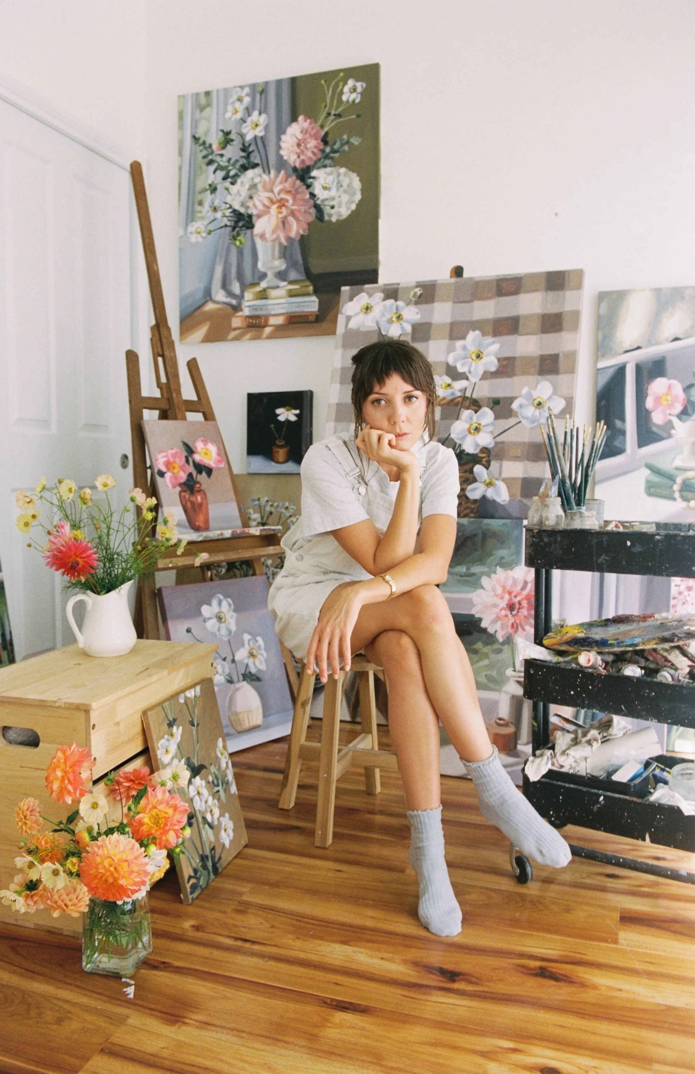An artist sitting infront of an easle
