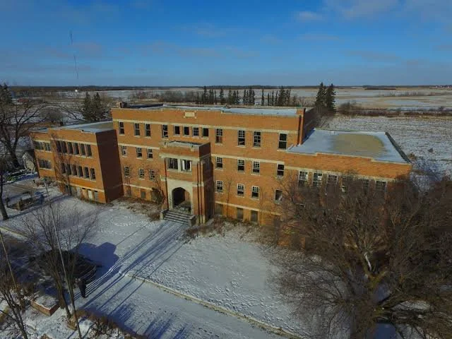 An image of the front of the Birtle Residential School in winter