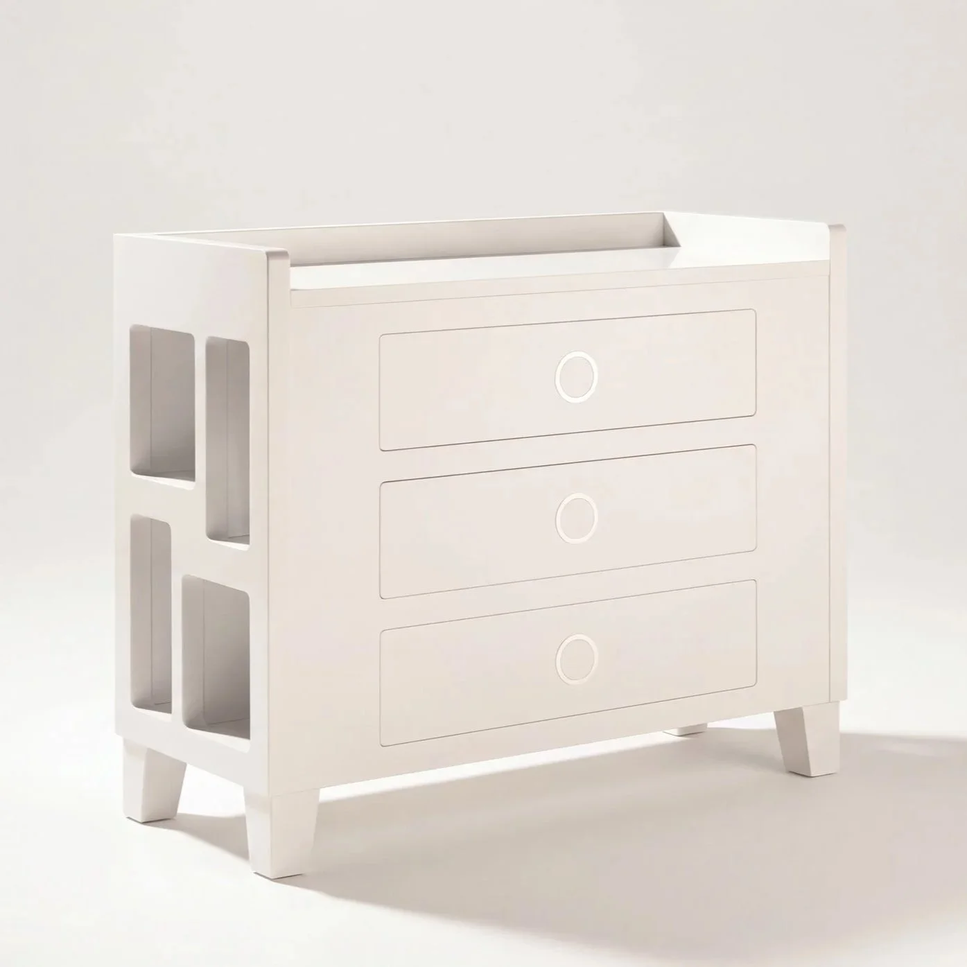 Three-quarter view of SUOMMO Nexus Changing Table, luxury baby changing table with drawers and open side storage compartments.