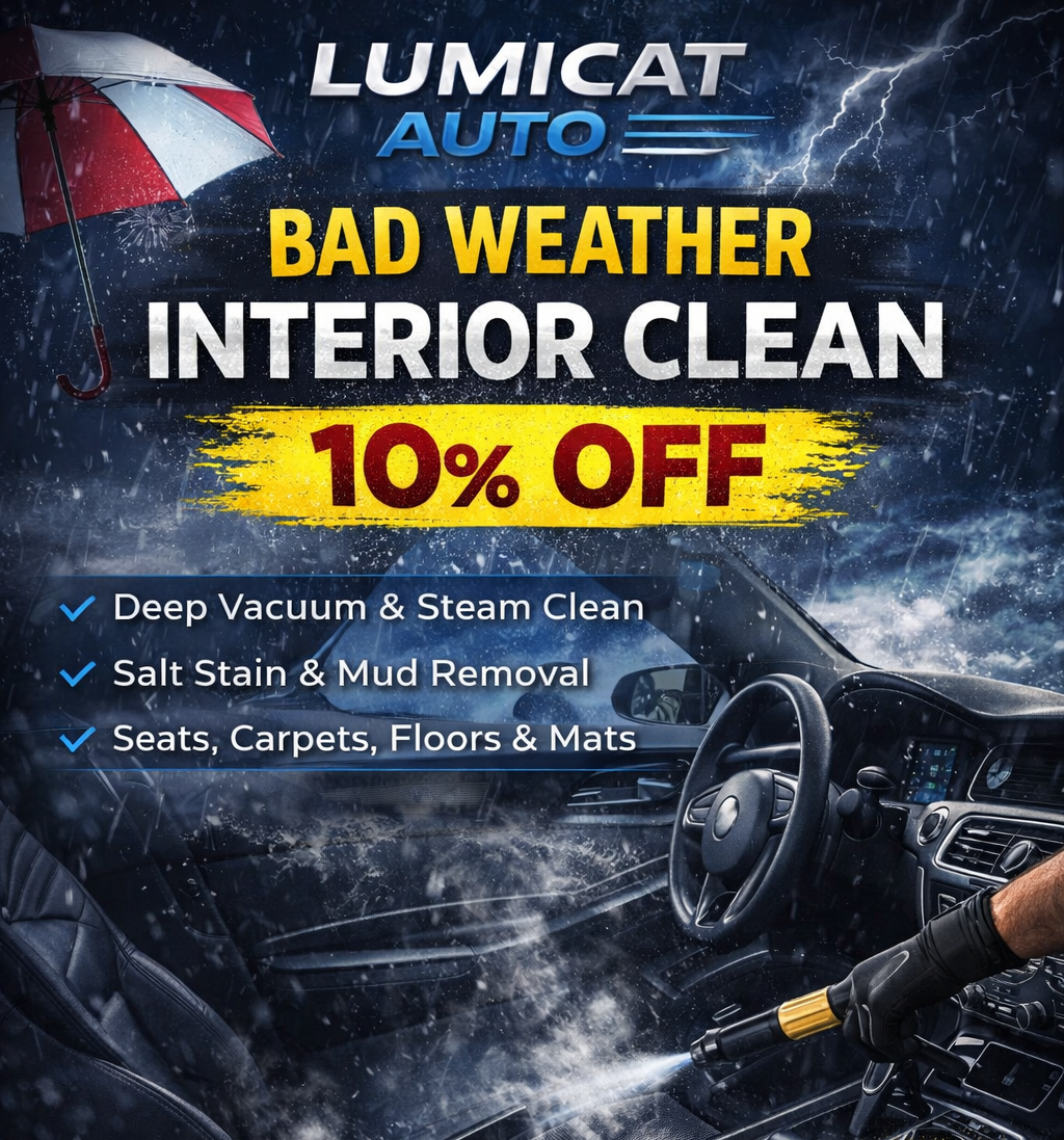 Close-up of a sleek, dark-colored car's front headlight and wheel.