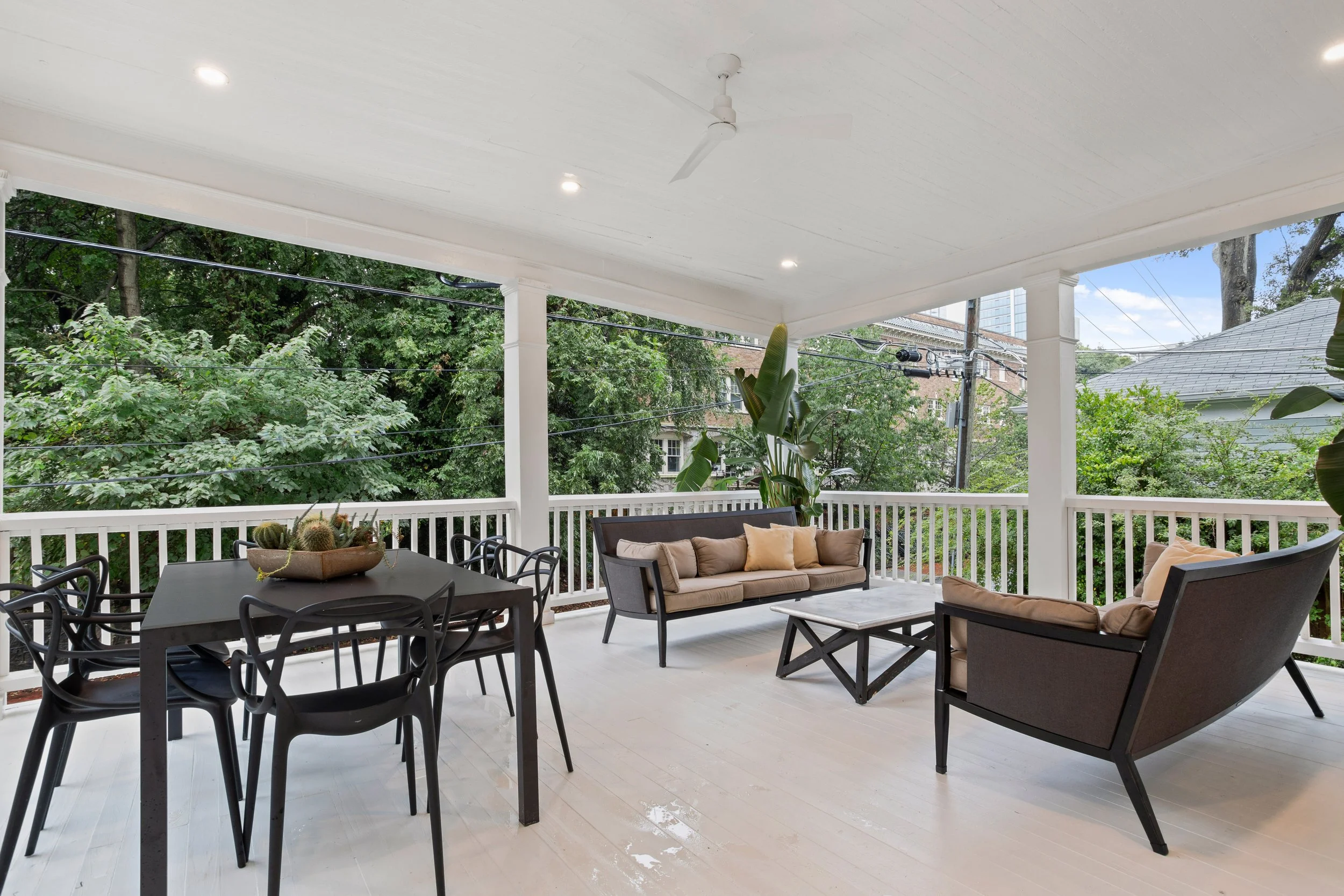 A refreshed front porch creates a gracious outdoor living space designed for both gathering and dining. With more than 300 square feet of usable space, the porch easily accommodates a dining table for six along with two full-sized couches and a centr