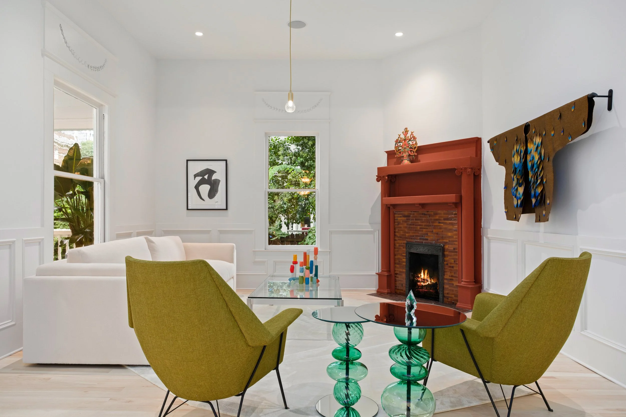 The wall leading into what was formerly the kitchen was closed to create a new primary bedroom. The original fireplace and mantel were refinished in a complementary tone that highlights and enhances the home’s beautifully preserved original tile.