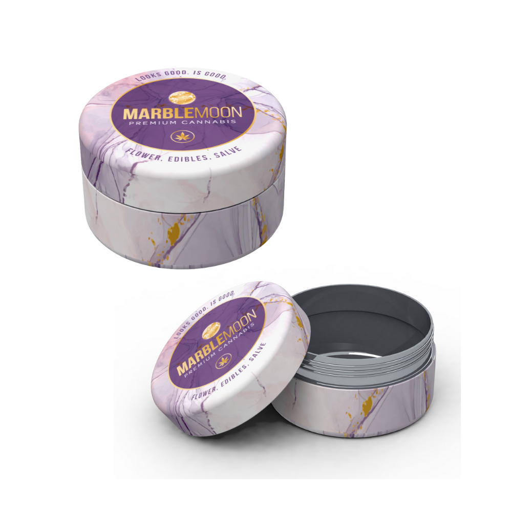 Open round container labeled Marblmoon Premium Cannabis with purple and gold marble design, containing cannabis flower edibles salve.
