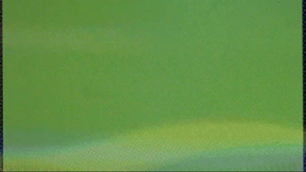 Green computer monitor displaying a pixelated screen with horizontal lines.