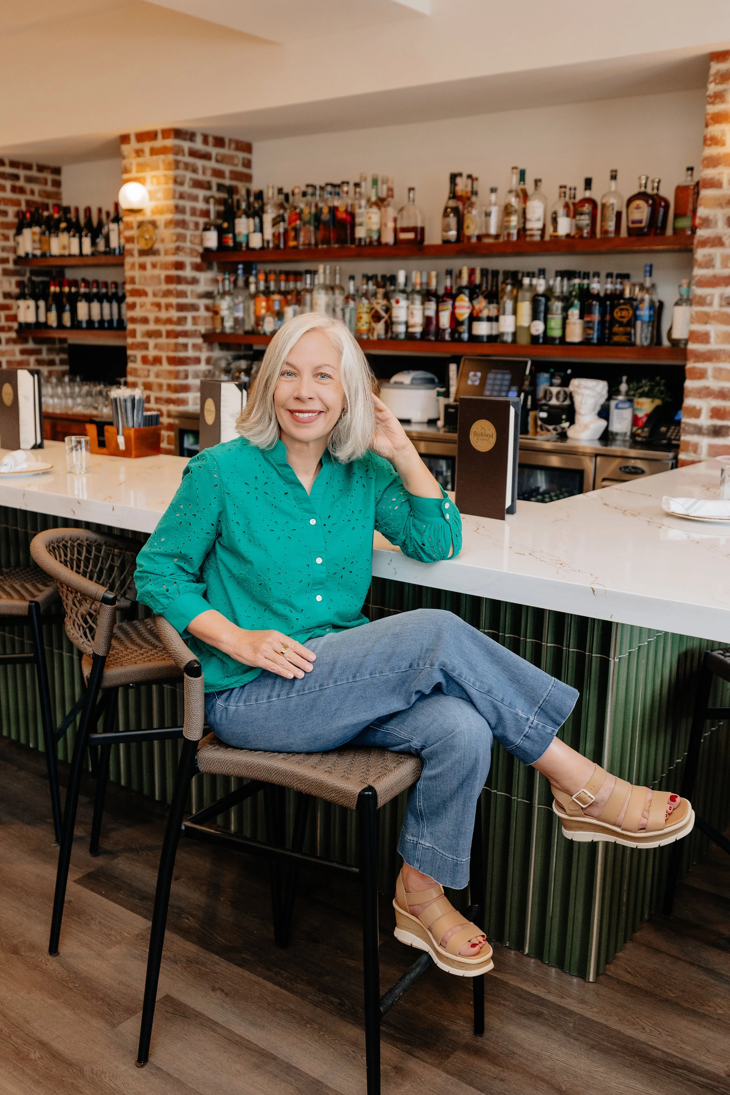 rish Cossart of Cossart Design inside Trattoria di Napoli in downtown Perry, GA, showcasing luxury commercial interior design with rich textures and Italian-inspired elegance.