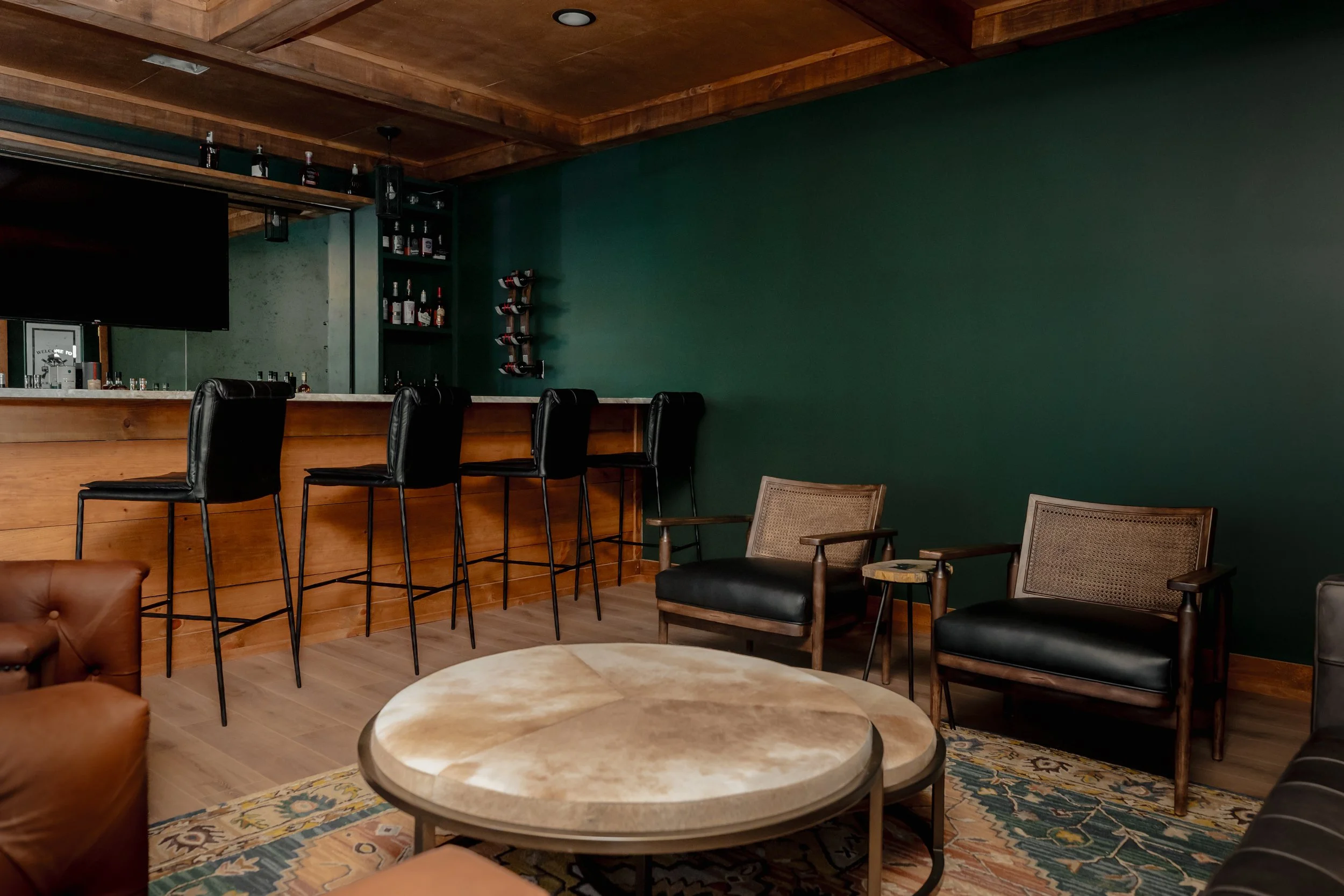 A refined cigar and whisky bar lounge designed by Cossart Design, where rich materials, warm lighting, and custom millwork come together to create a sophisticated retreat within this custom Southern home. Thoughtfully layered textures and bespoke sea