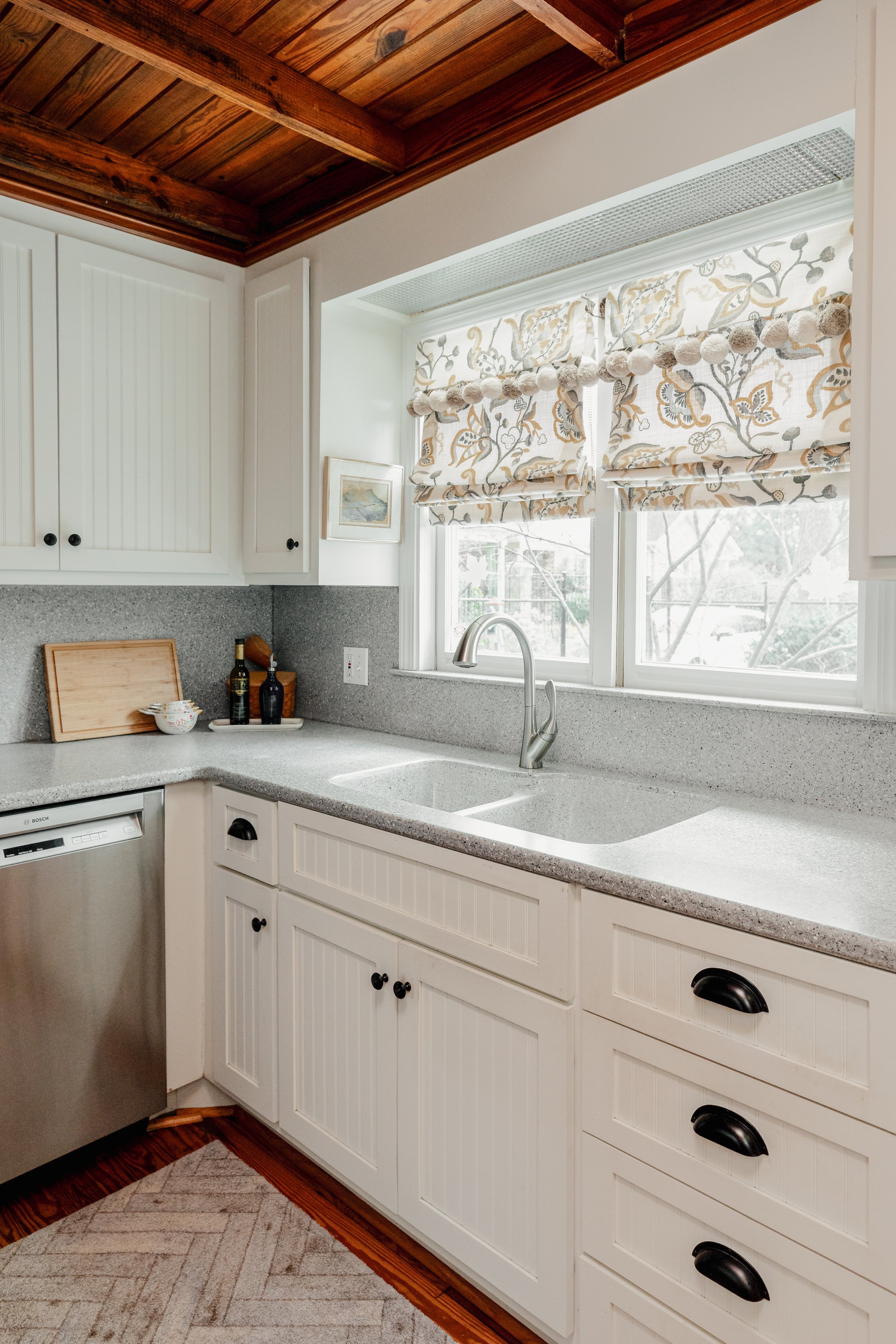 A classic kitchen designed by Cossart Design in Perry, GA, where timeless details meet modern functionality. Custom cabinetry, tailored window treatments, and carefully curated finishes create a space that is both elegant and inviting. The adjacent b