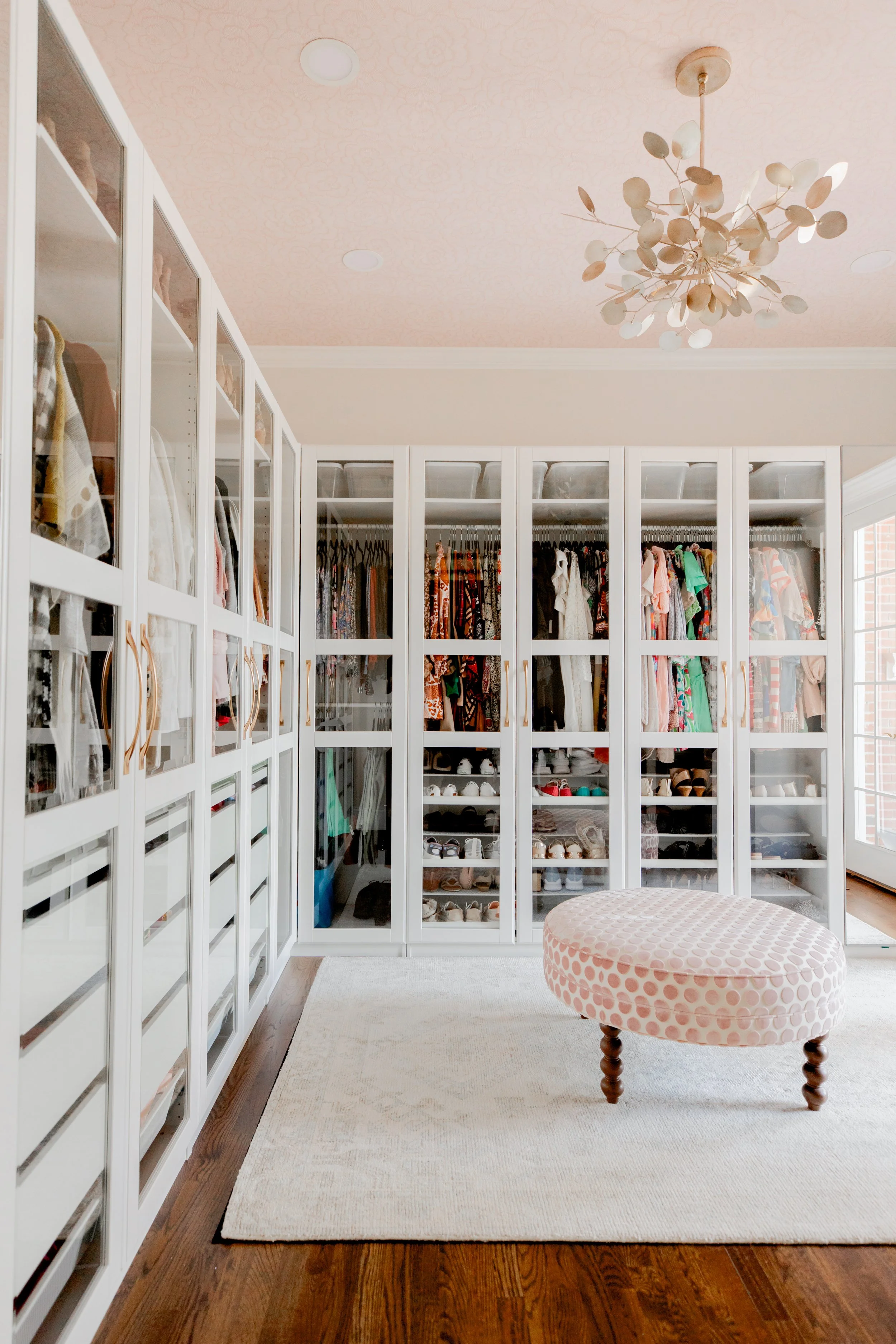 A custom master closet by Cossart Design, thoughtfully designed with tailored cabinetry, personalized shelving, and sophisticated storage solutions. The space combines luxury and functionality, making organization effortless while maintaining a curat