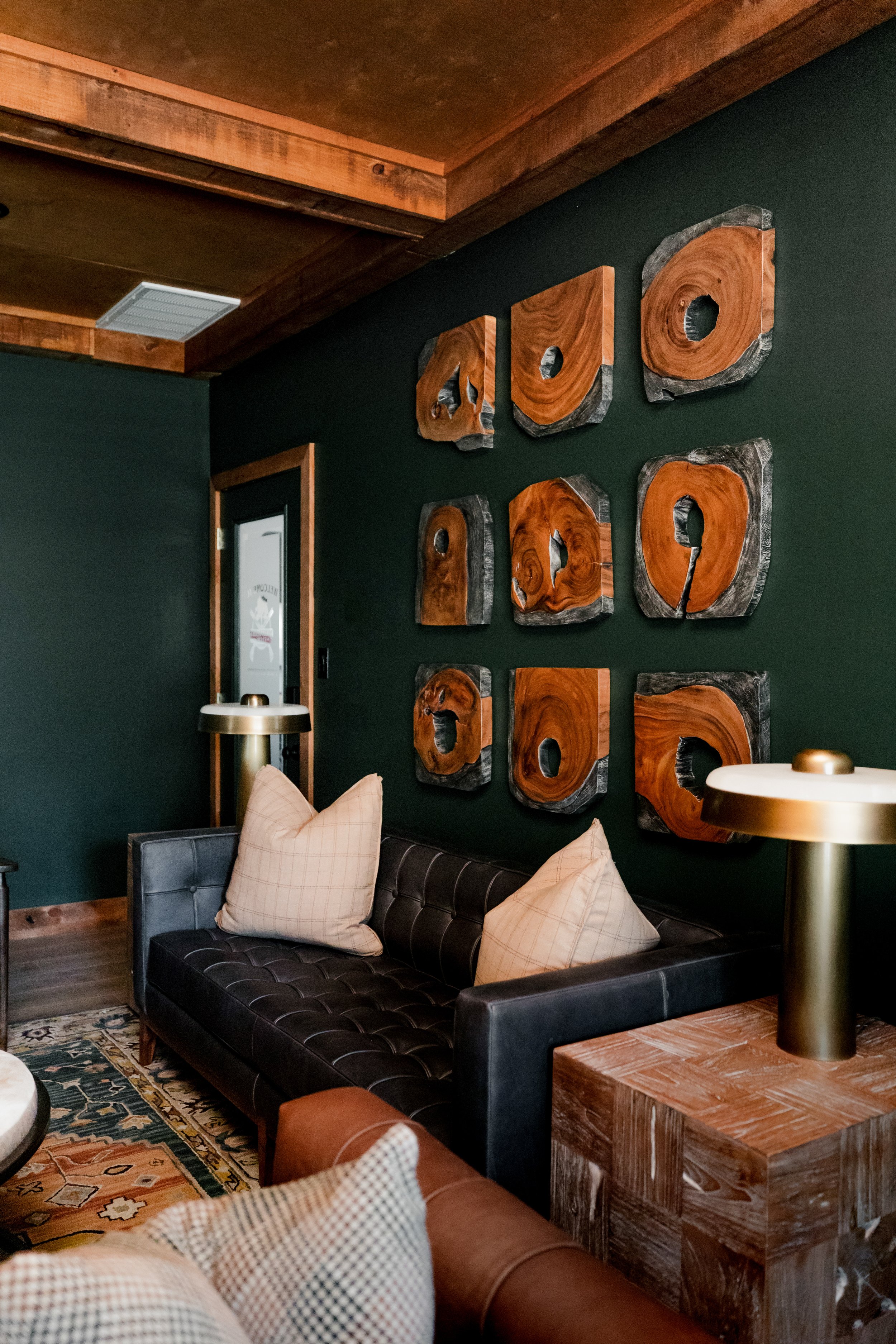 A refined cigar and whisky bar lounge designed by Cossart Design, where rich materials, warm lighting, and custom millwork come together to create a sophisticated retreat within this custom Southern home. Thoughtfully layered textures and bespoke sea