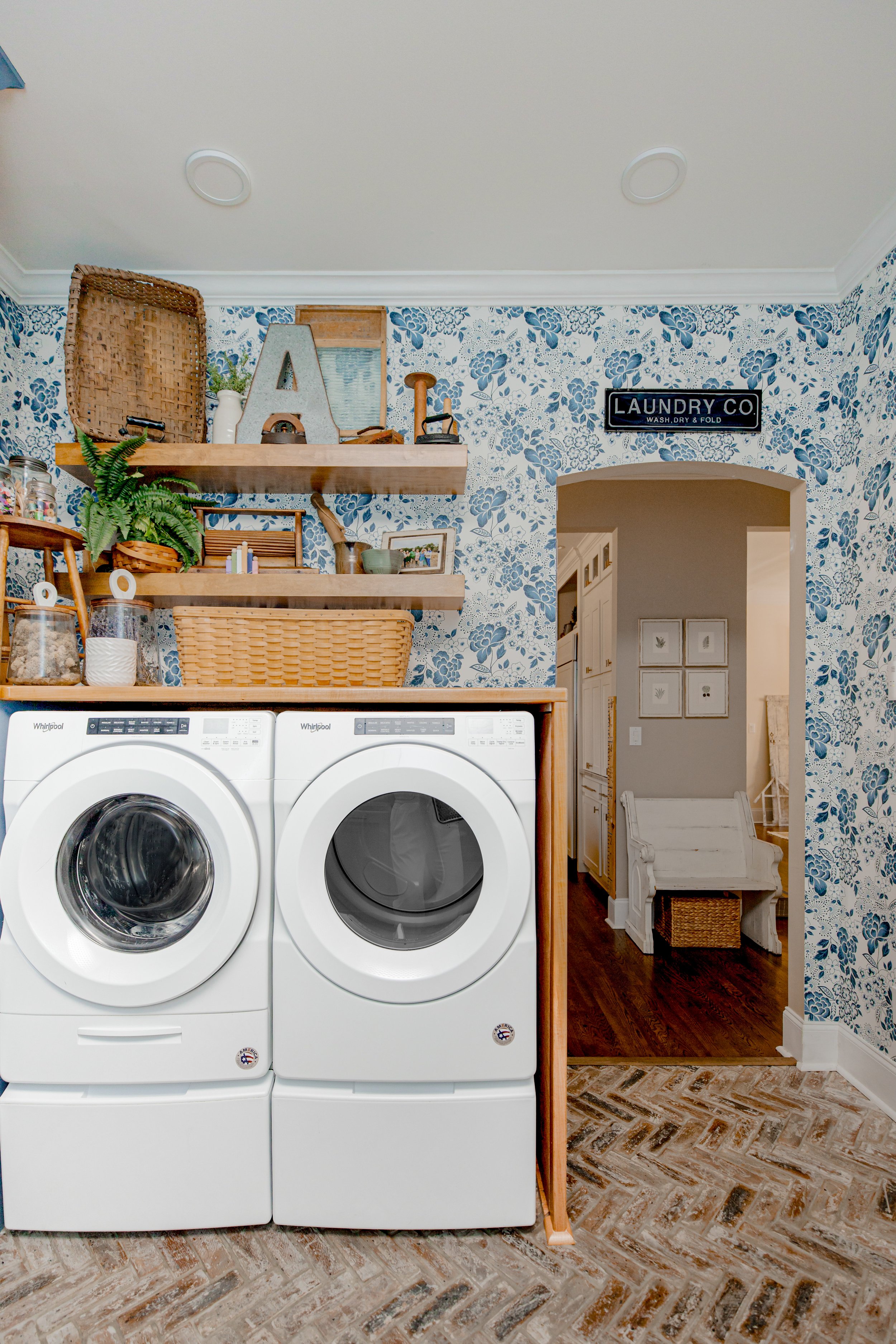 A functional yet luxurious laundry room by Cossart Design, featuring custom cabinetry, elevated finishes, and organized storage solutions that make daily routines seamless. The design combines practicality and beauty, with a sophisticated palette, el