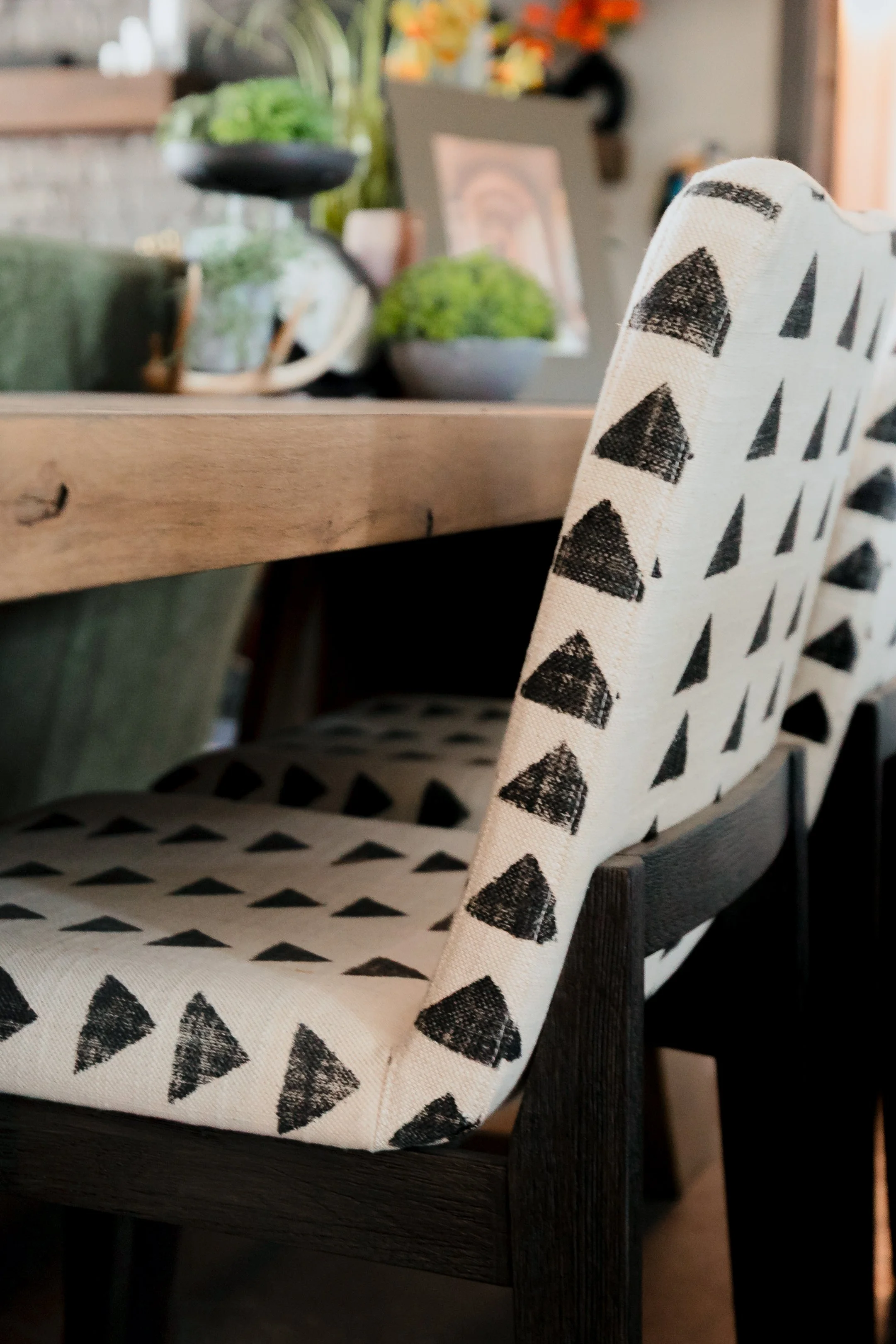 A striking open concept living space by Cossart Design in this Hawkinsville, GA barndominium that masterfully blends industrial accents with masculine design. Rich green and wood tones, along with modern tailored furnishings create a lodge‑inspired e