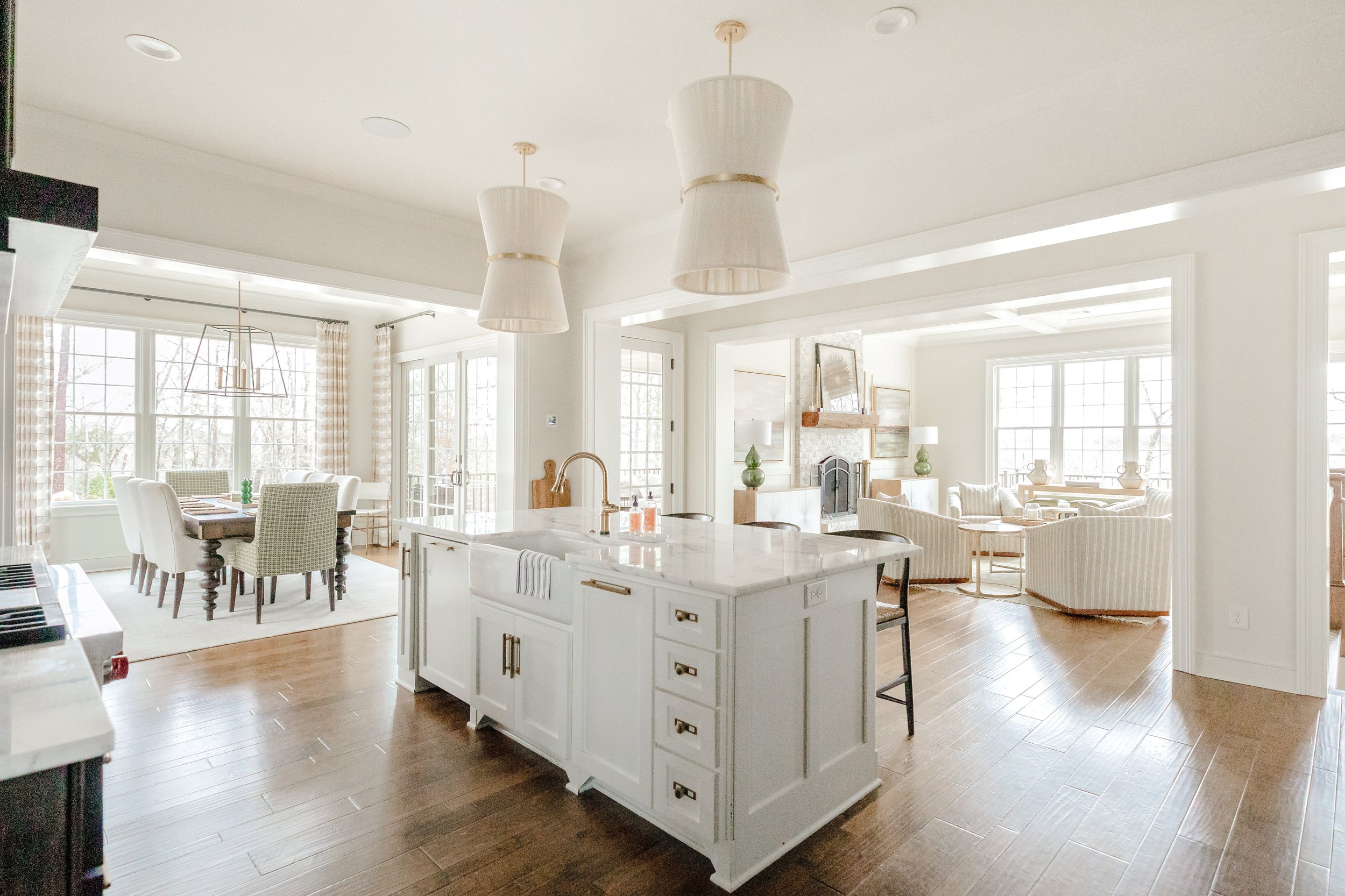 A classic kitchen with custom cabinetry and tailored finishes by Cossart Design, featuring a functional layout and luxurious details including contemporary and timeless lighting fixtures. The Allendale kitchen blends elegance and practicality for dai