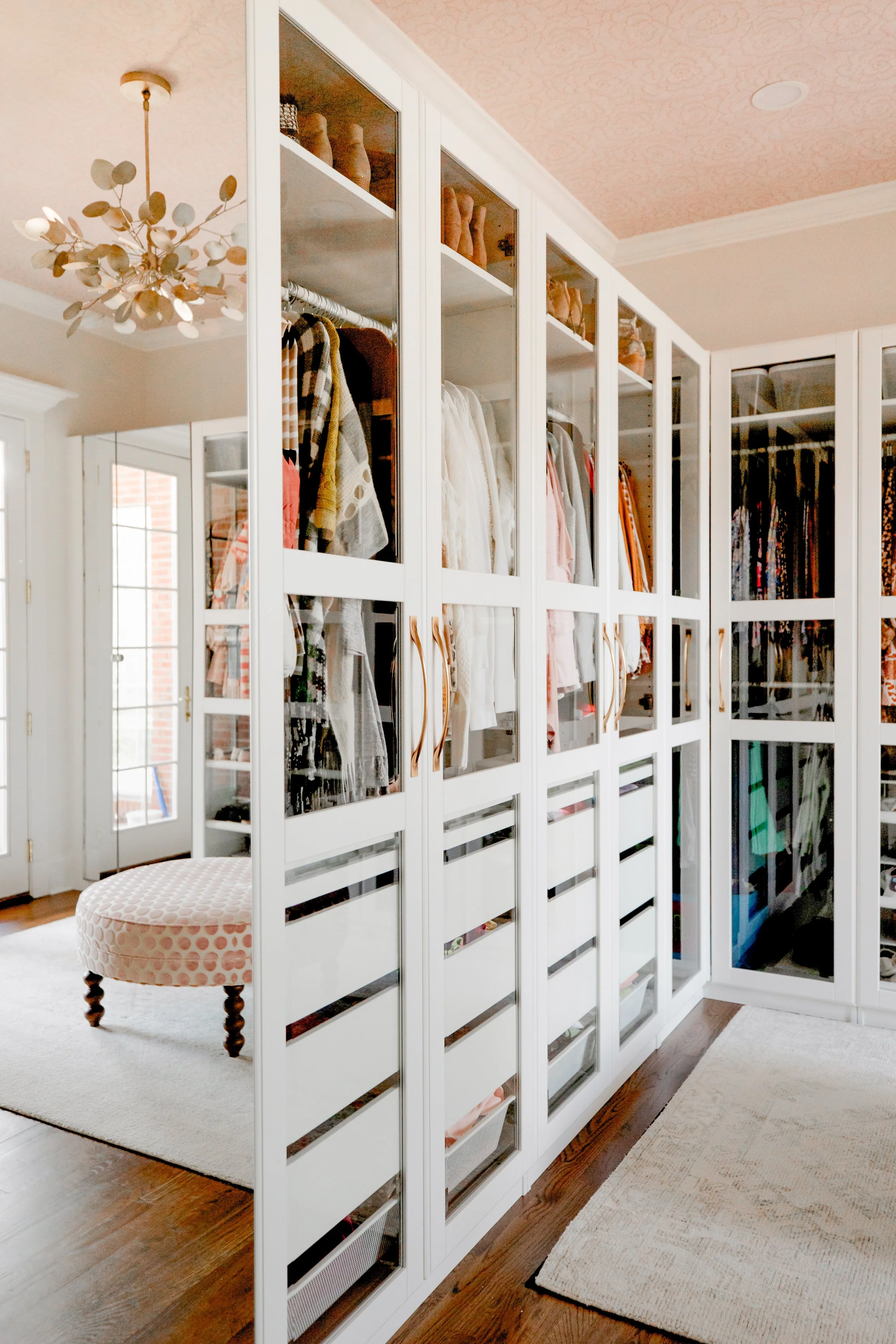 A custom master closet by Cossart Design, thoughtfully designed with tailored cabinetry, personalized shelving, and sophisticated storage solutions. The space combines luxury and functionality, making organization effortless while maintaining a curat