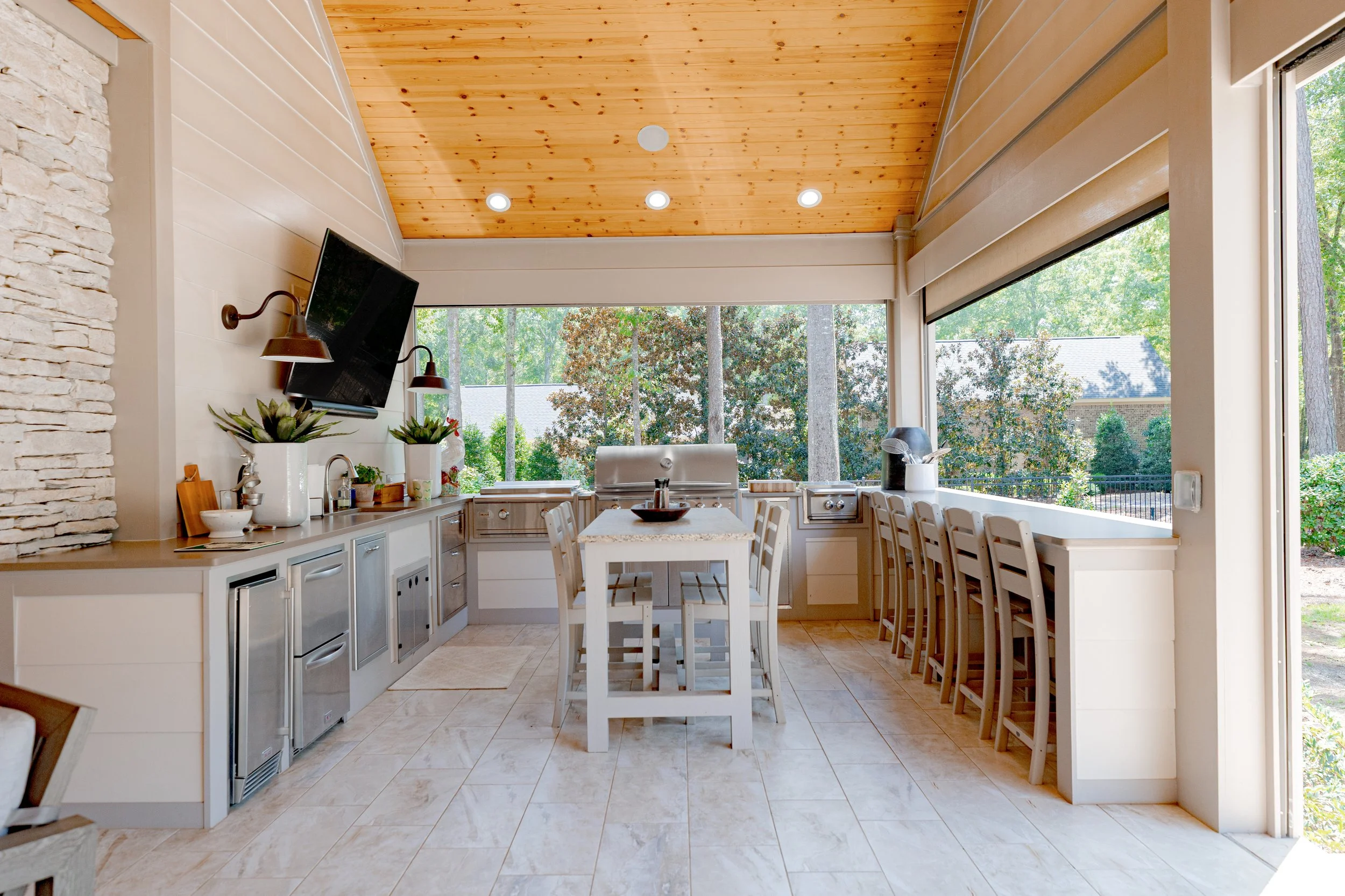 This outdoor living space was thoughtfully designed to overlook the pool and backyard oasis, creating a seamless extension of the home. Custom furnishings, layered décor, and intentional layouts offer a refined yet relaxed setting for gathering, ente