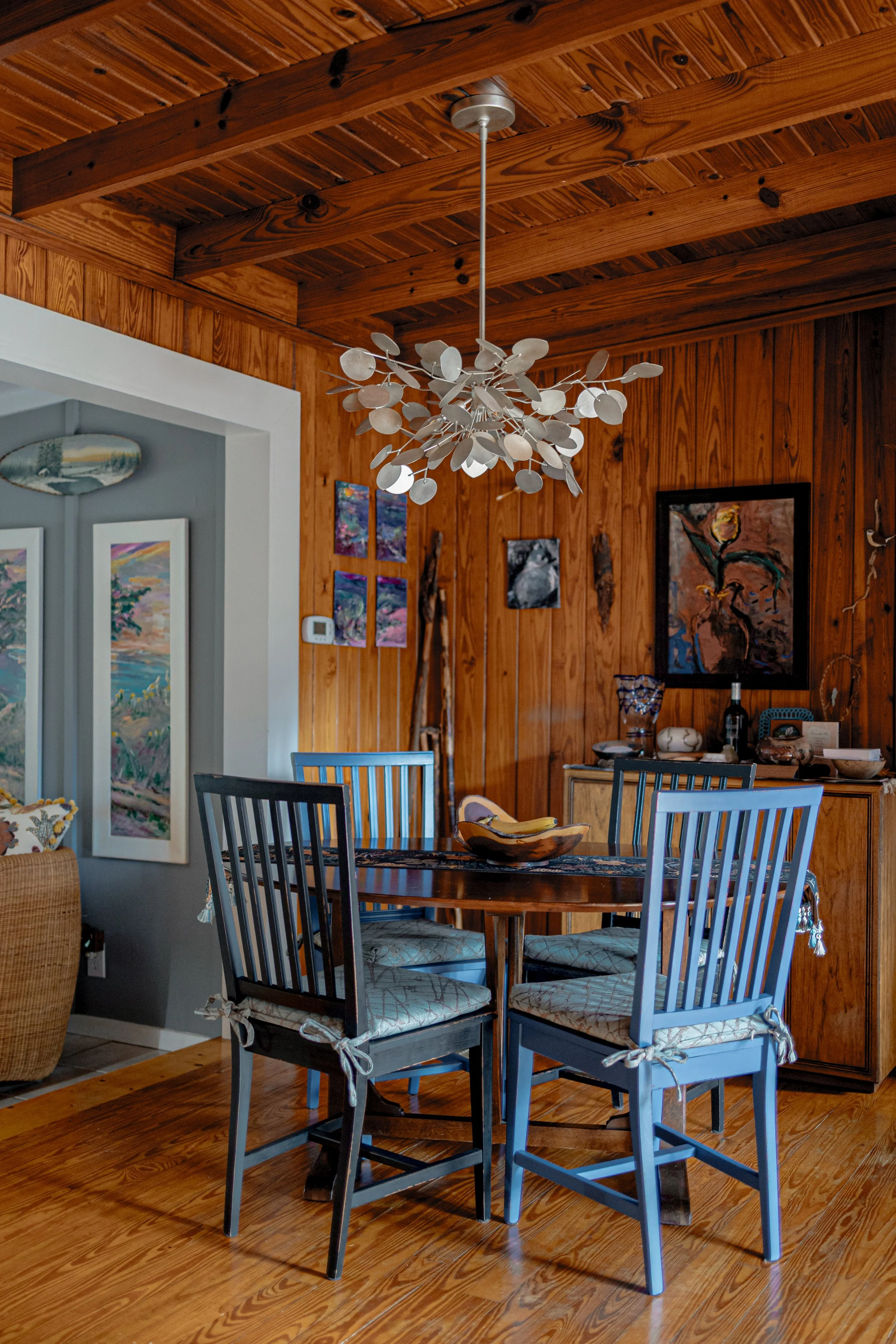 Detail of a dining or gathering space enhanced with curated design elements, custom chandelier, and tailored finishes that bring cohesion and warmth. Designed by Cossart Design, this vignette highlights how intentional styling elevates everyday space