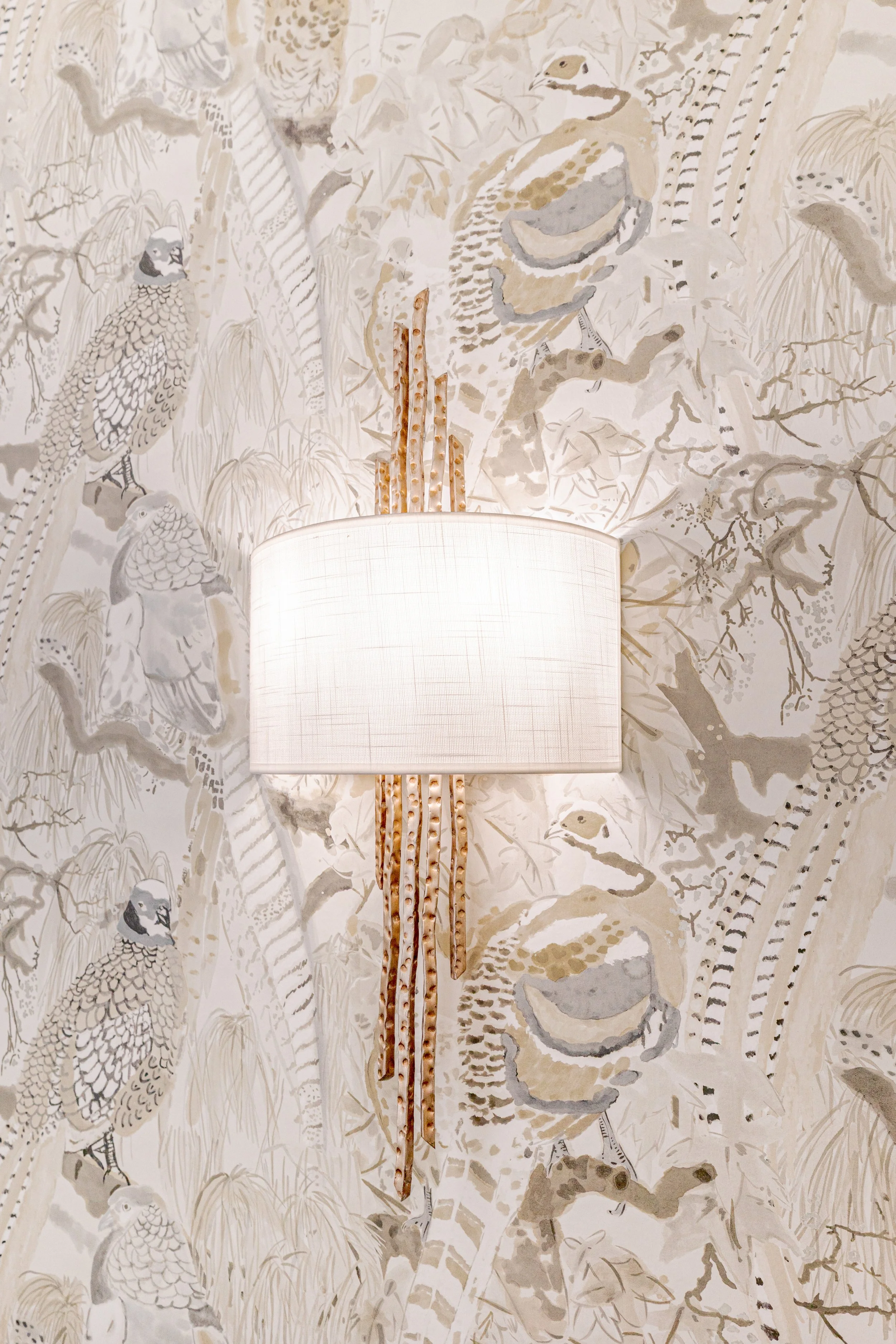 A spa-inspired primary bathroom designed for relaxation and daily ritual. Elevated materials, balanced lighting, and thoughtful layouts create a space that feels calming, timeless, and refined. The textured wallpaper custom tile, and gold finishes br