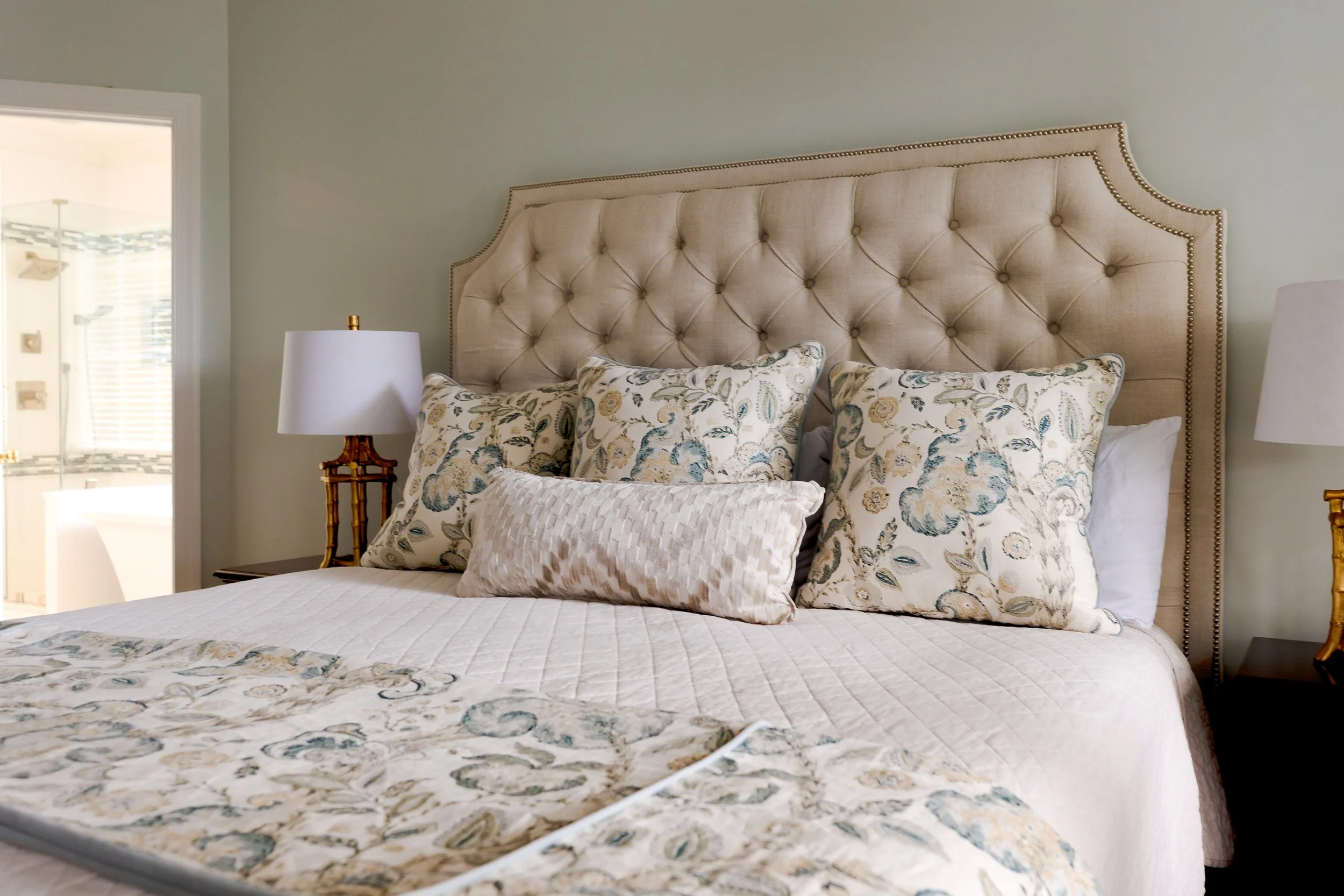 A serene master bedroom designed by Cossart Design, with soft hues, layered textures, and custom window treatments. This luxurious retreat balances comfort and elegance, offering a personal sanctuary within this quintessential Southern home.
#MasterB
