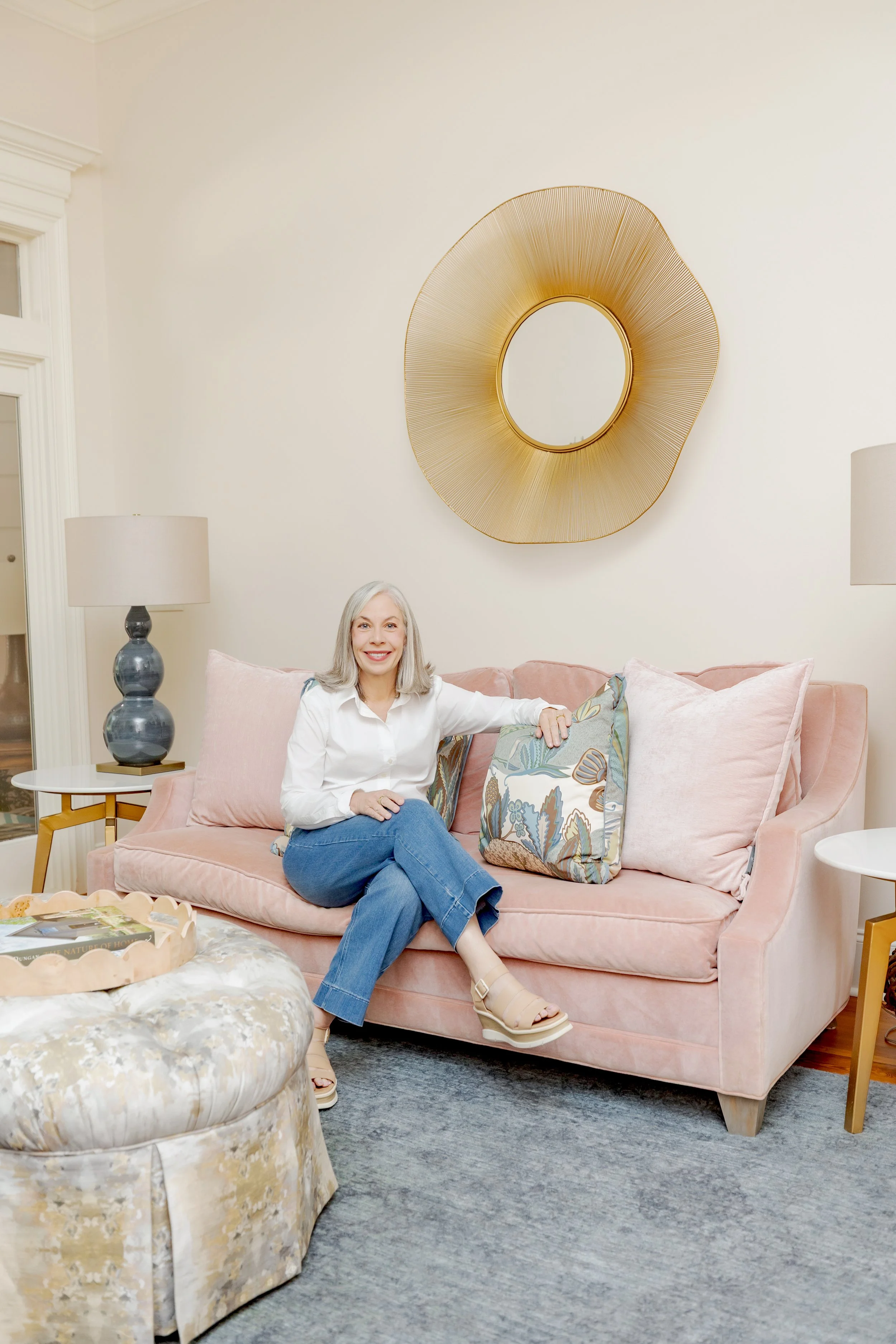 Trish Cossart of Cossart Design in Perry, GA, seated in a cozy luxury sitting room she designed with custom finishes and Southern style.