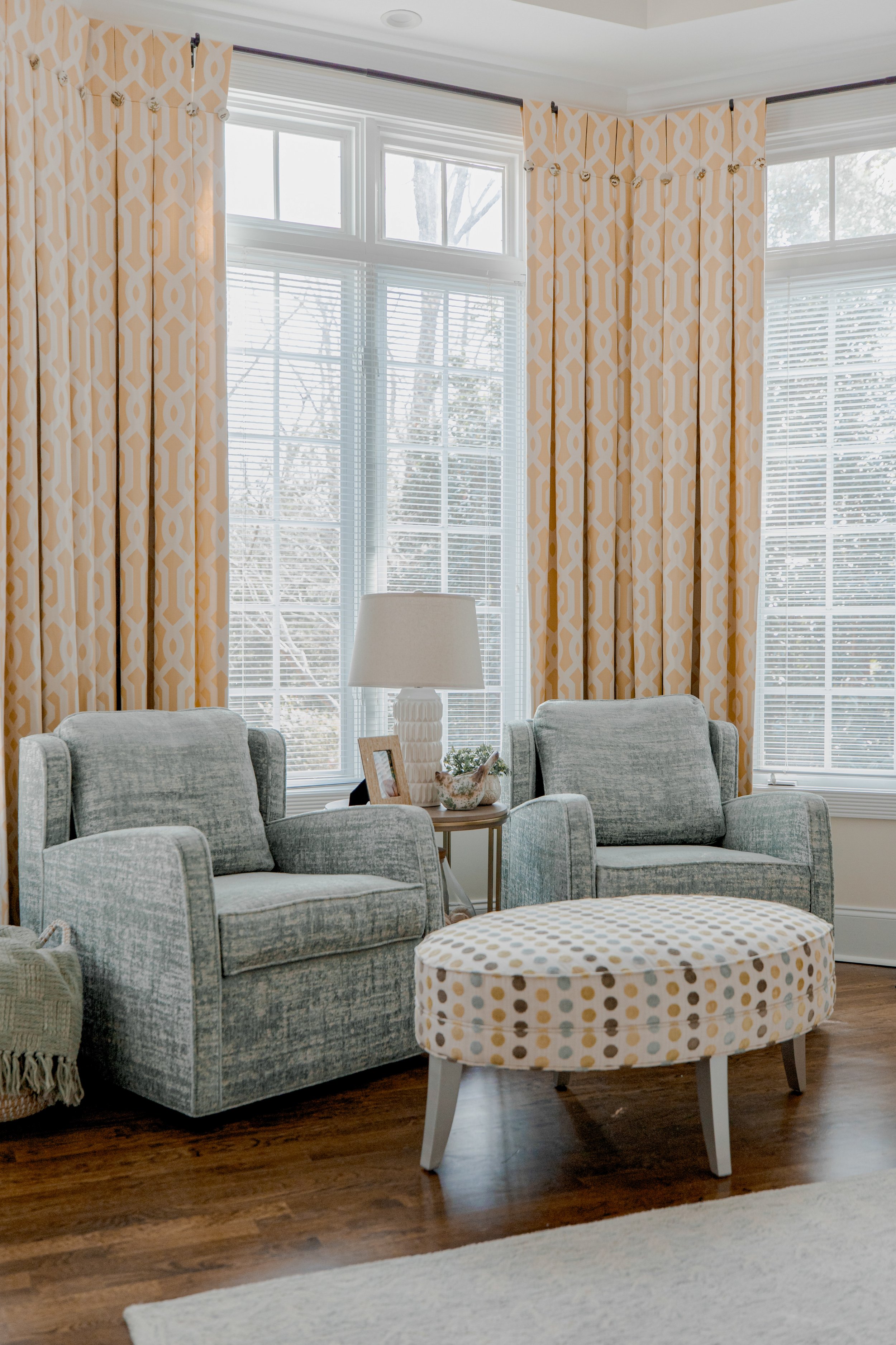 A serene and luxurious master bedroom designed by Cossart Design, featuring layered textures, custom bedding, and thoughtfully curated furnishings. The space balances elegance and comfort with warm tones, soft lighting, and functional seating areas t
