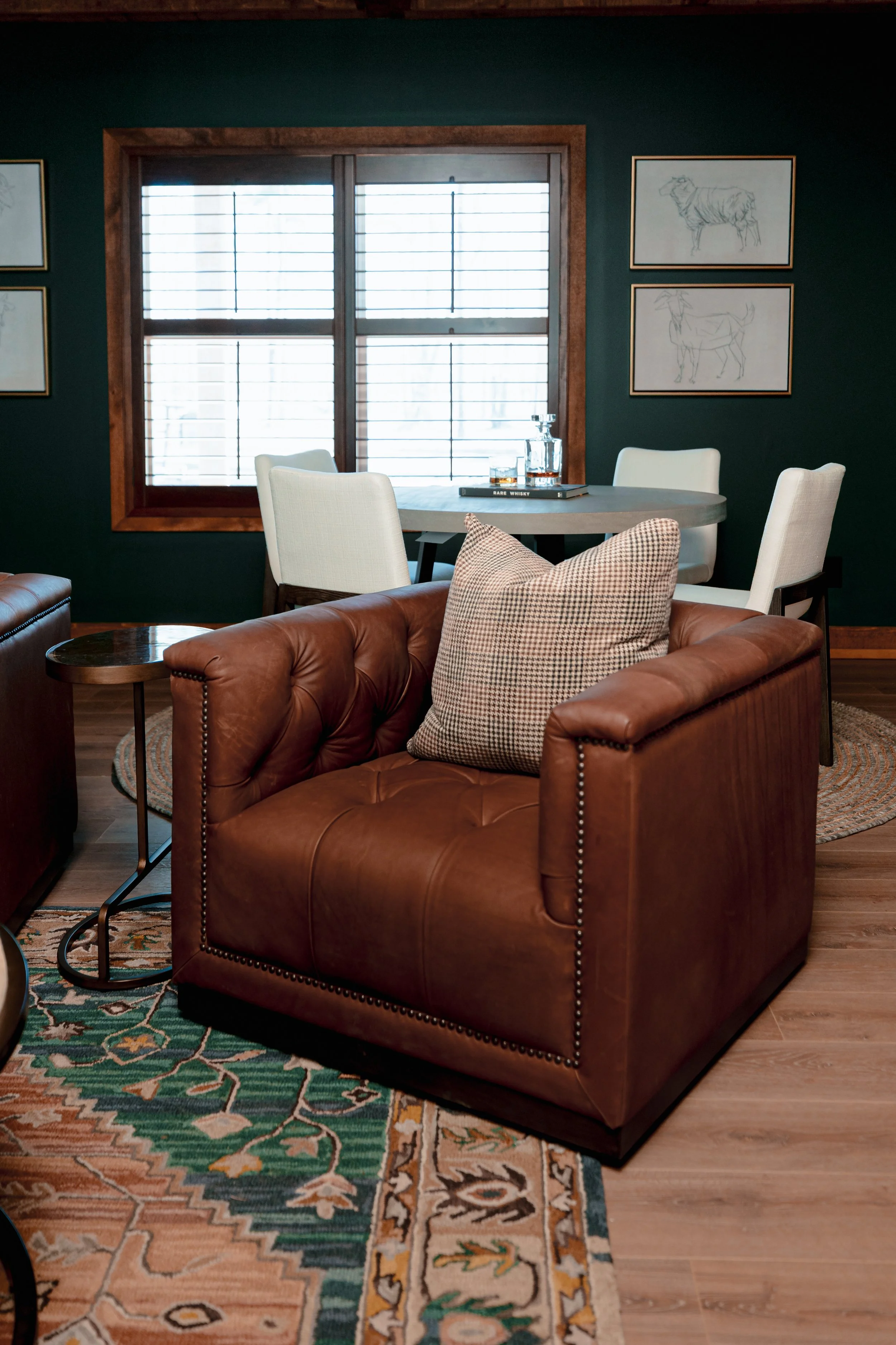A refined cigar and whisky bar lounge designed by Cossart Design, where rich materials, warm lighting, and custom millwork come together to create a sophisticated retreat within this custom Southern home. Thoughtfully layered textures and bespoke sea