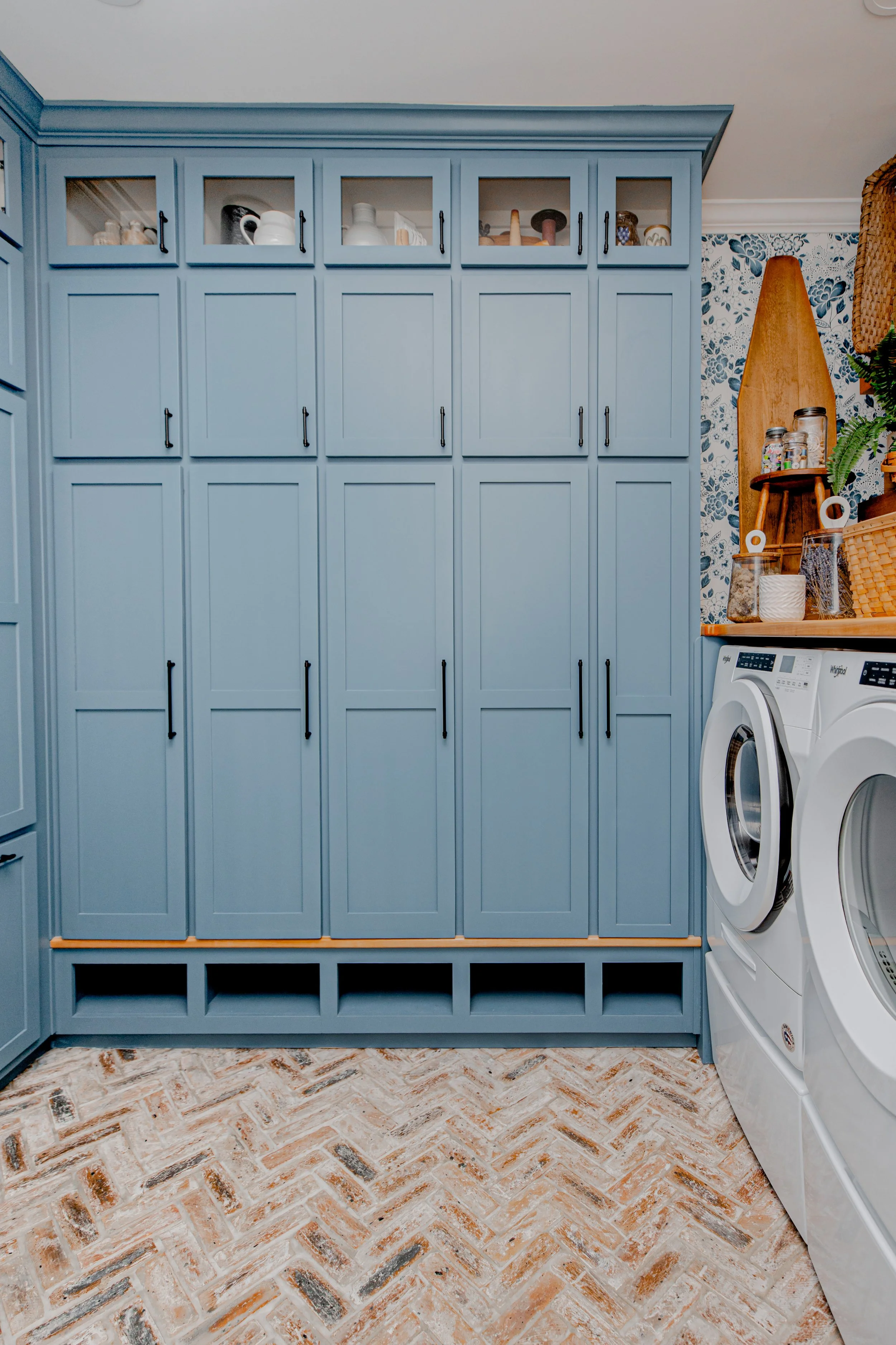 A functional yet luxurious laundry room by Cossart Design, featuring custom cabinetry, elevated finishes, and organized storage solutions that make daily routines seamless. The design combines practicality and beauty, with a sophisticated palette, el