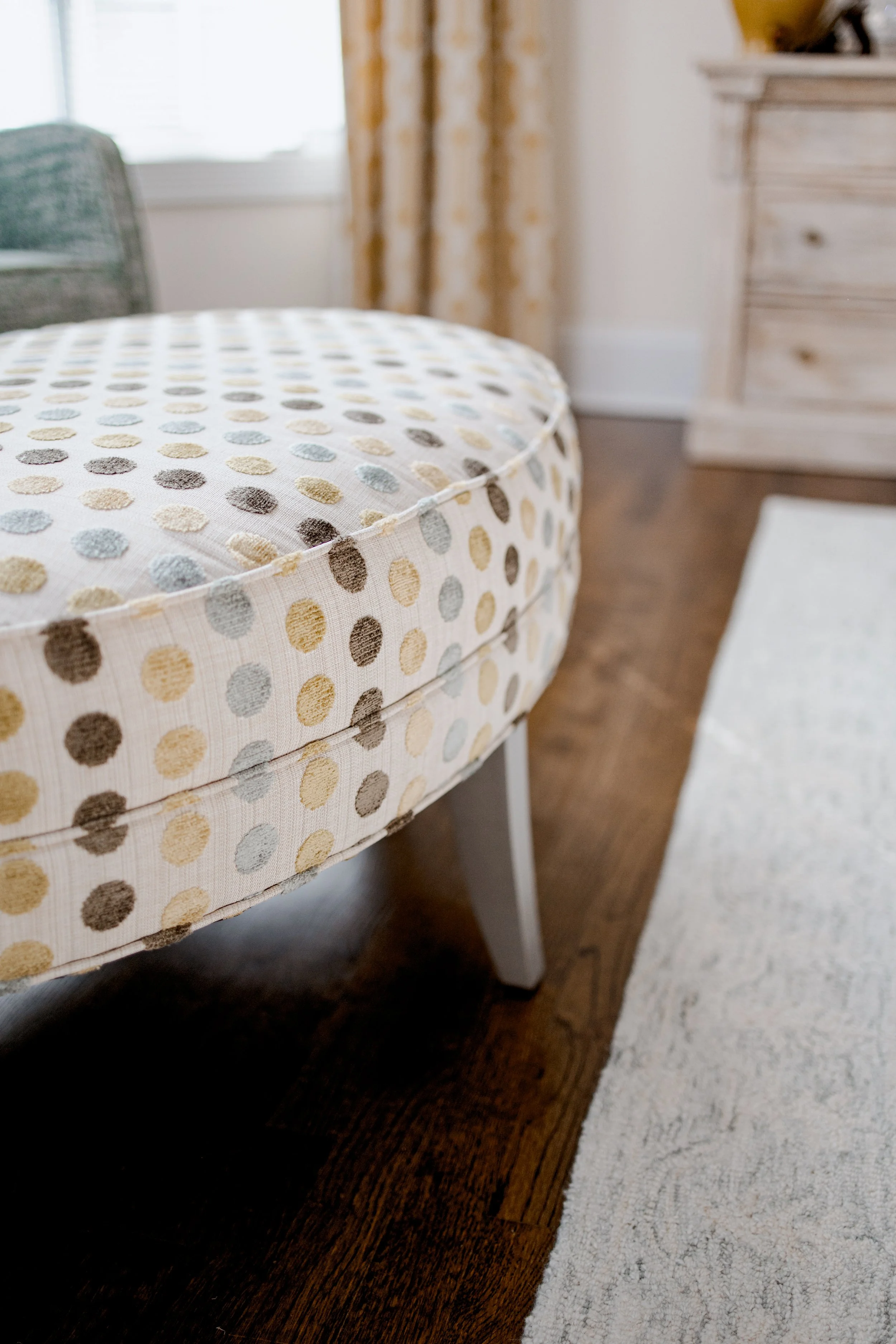 A serene and luxurious master bedroom designed by Cossart Design, featuring layered textures, custom bedding, and thoughtfully curated furnishings. The space balances elegance and comfort with warm tones, soft lighting, and functional seating areas t