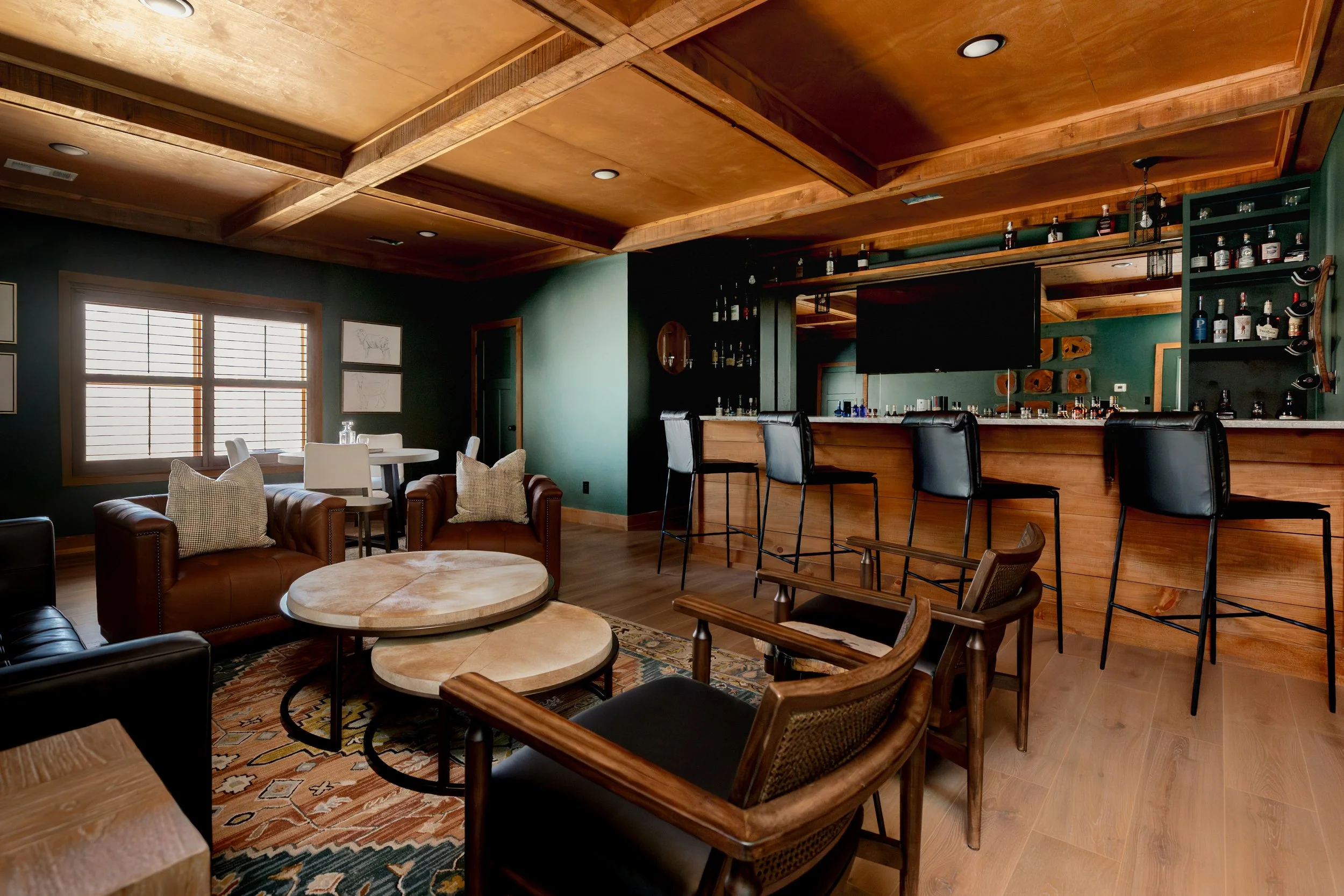 A refined cigar and whisky bar lounge designed by Cossart Design, where rich materials, warm lighting, and custom millwork come together to create a sophisticated retreat within this custom Southern home. Thoughtfully layered textures and bespoke sea