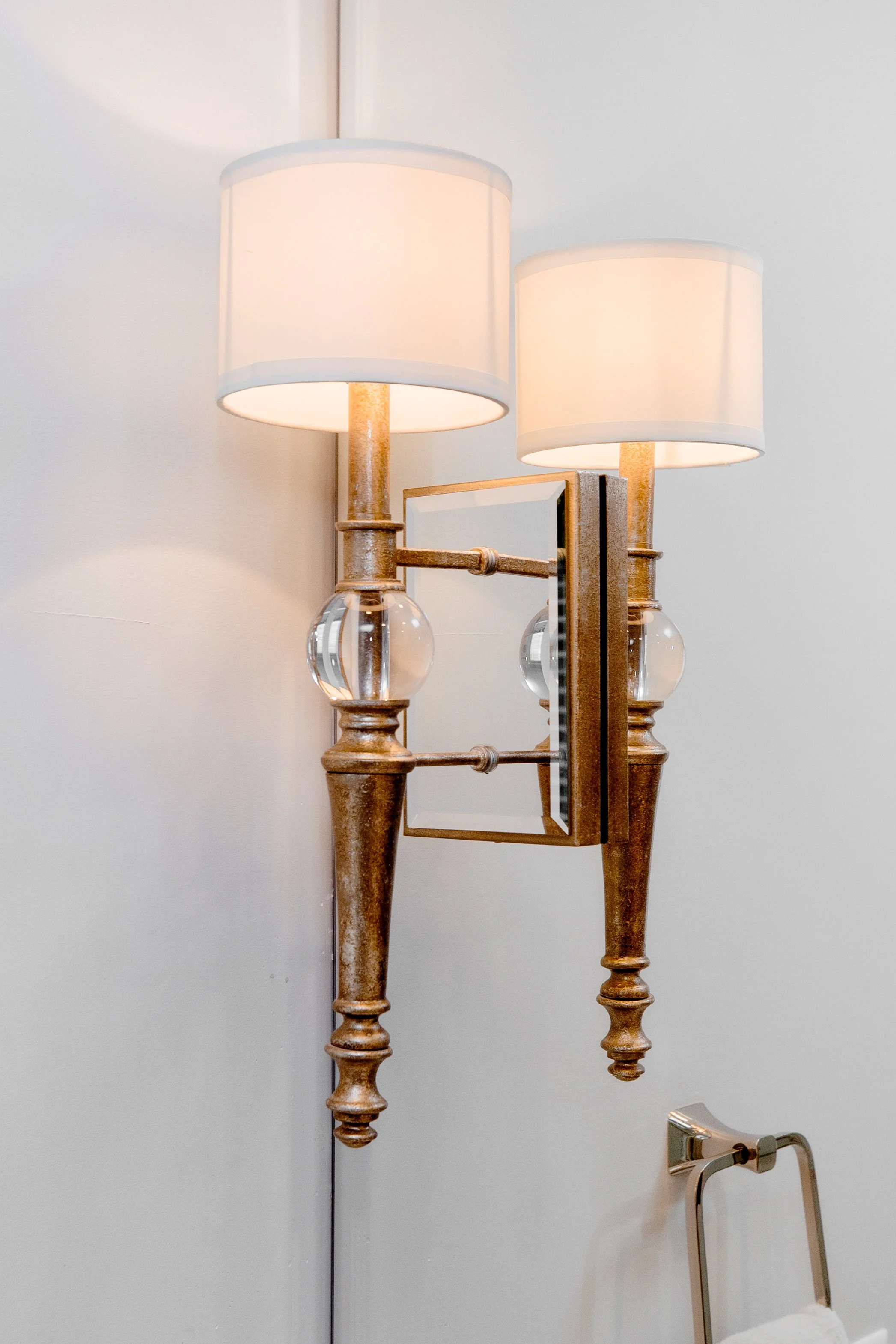 A spa-inspired master bathroom by Cossart Design, featuring custom herringbone floors, white and blue accents, a soaking tub, shower with custom tile, and luxurious gold fixtures. Designed for serenity, function, and elevated style, this space is a p