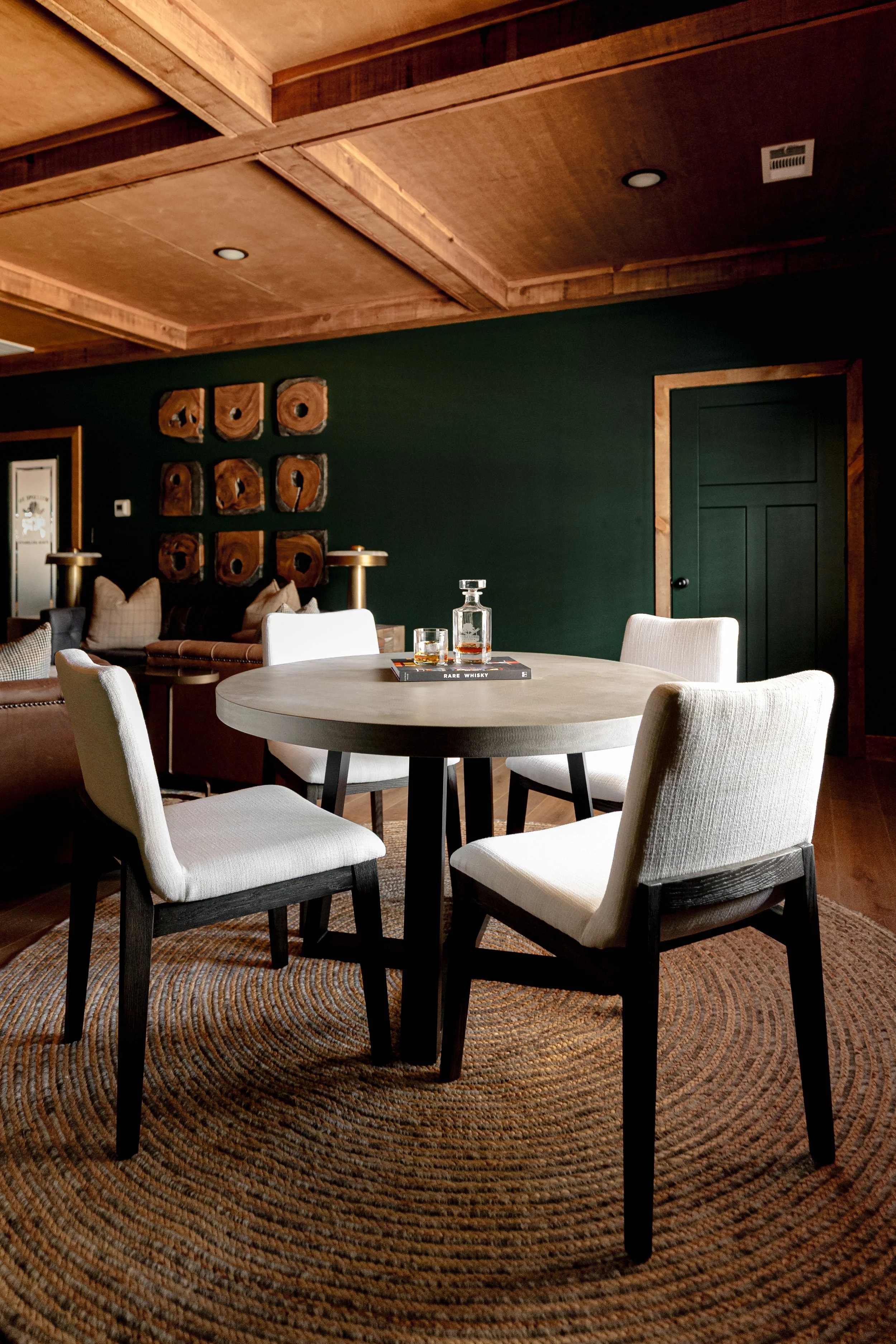 A refined cigar and whisky bar lounge designed by Cossart Design, where rich materials, warm lighting, and custom millwork come together to create a sophisticated retreat within this custom Southern home. Thoughtfully layered textures and bespoke sea