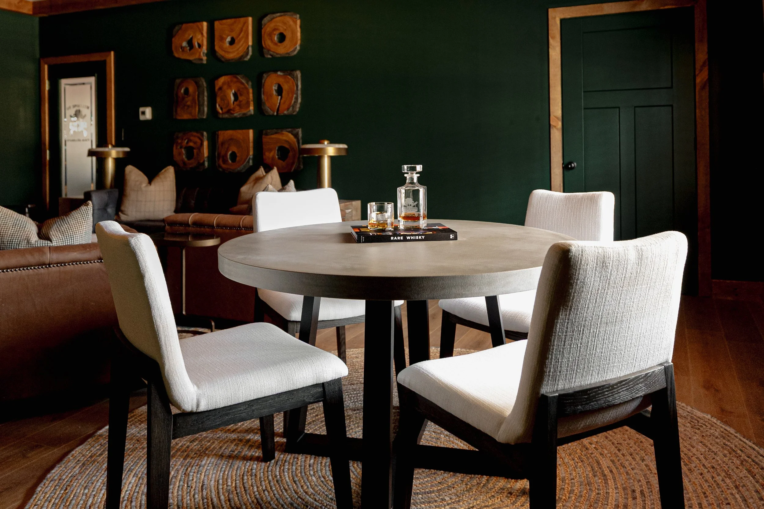 A refined cigar and whisky bar lounge designed by Cossart Design, where rich materials, warm lighting, and custom millwork come together to create a sophisticated retreat within this custom Southern home. Thoughtfully layered textures and bespoke sea