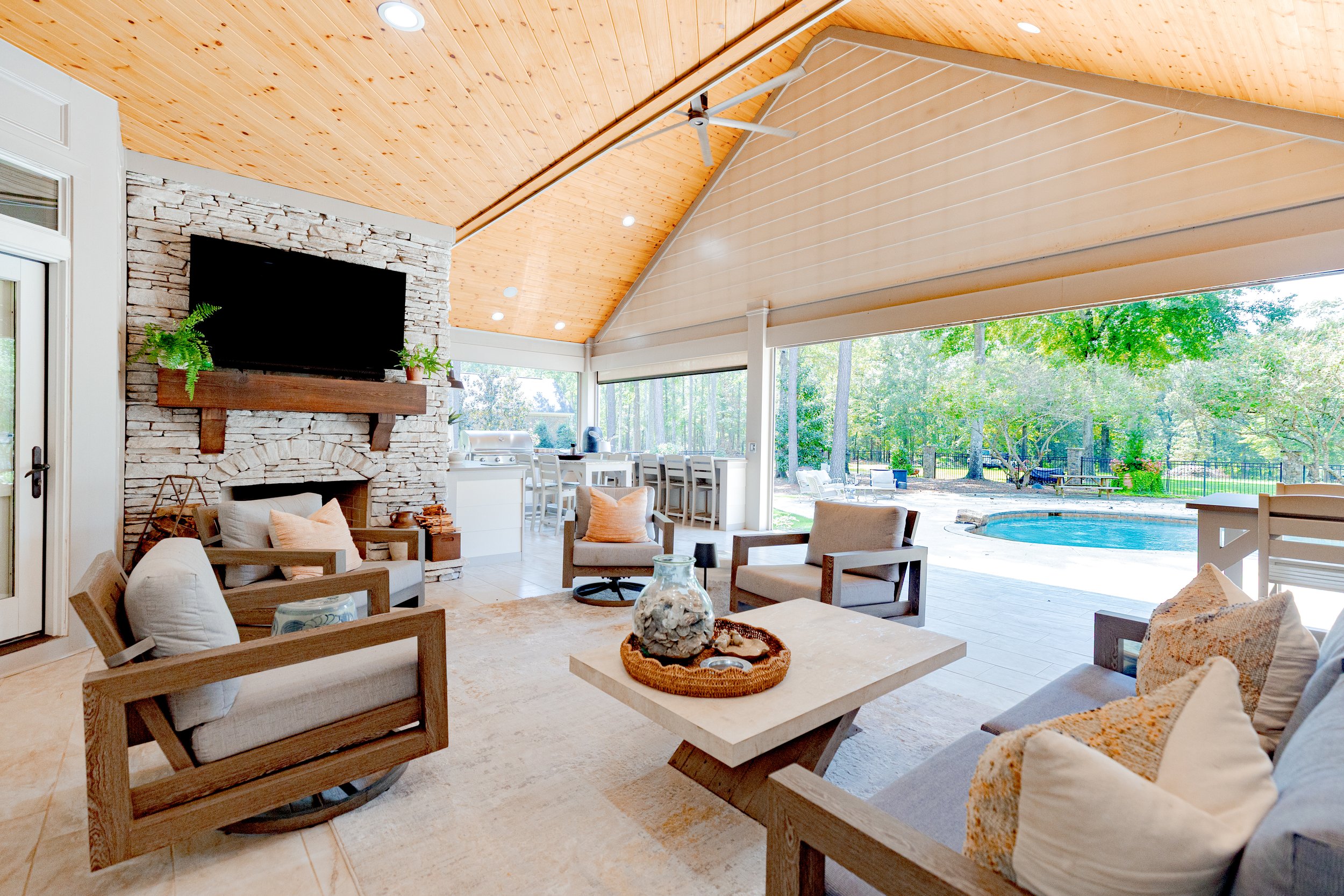 This outdoor living space was thoughtfully designed to overlook the pool and backyard oasis, creating a seamless extension of the home. Custom furnishings, layered décor, and intentional layouts offer a refined yet relaxed setting for gathering, ente