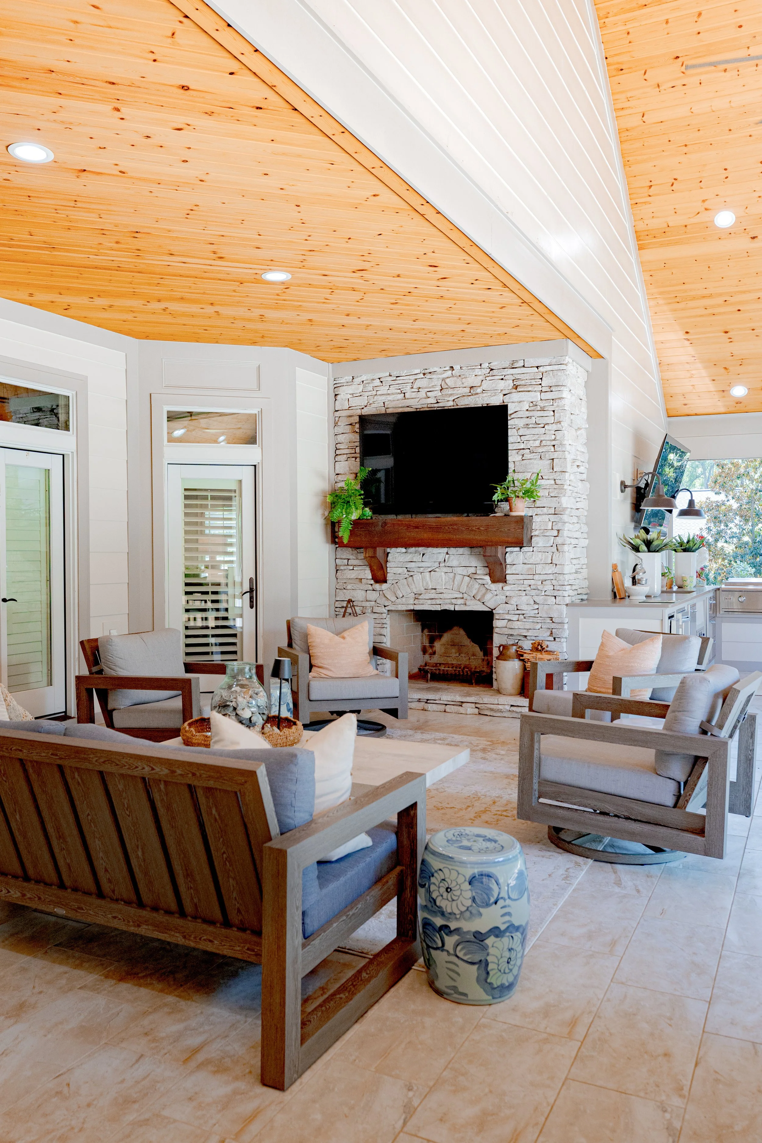 This outdoor living space was thoughtfully designed to overlook the pool and backyard oasis, creating a seamless extension of the home. Custom furnishings, layered décor, and intentional layouts offer a refined yet relaxed setting for gathering, ente