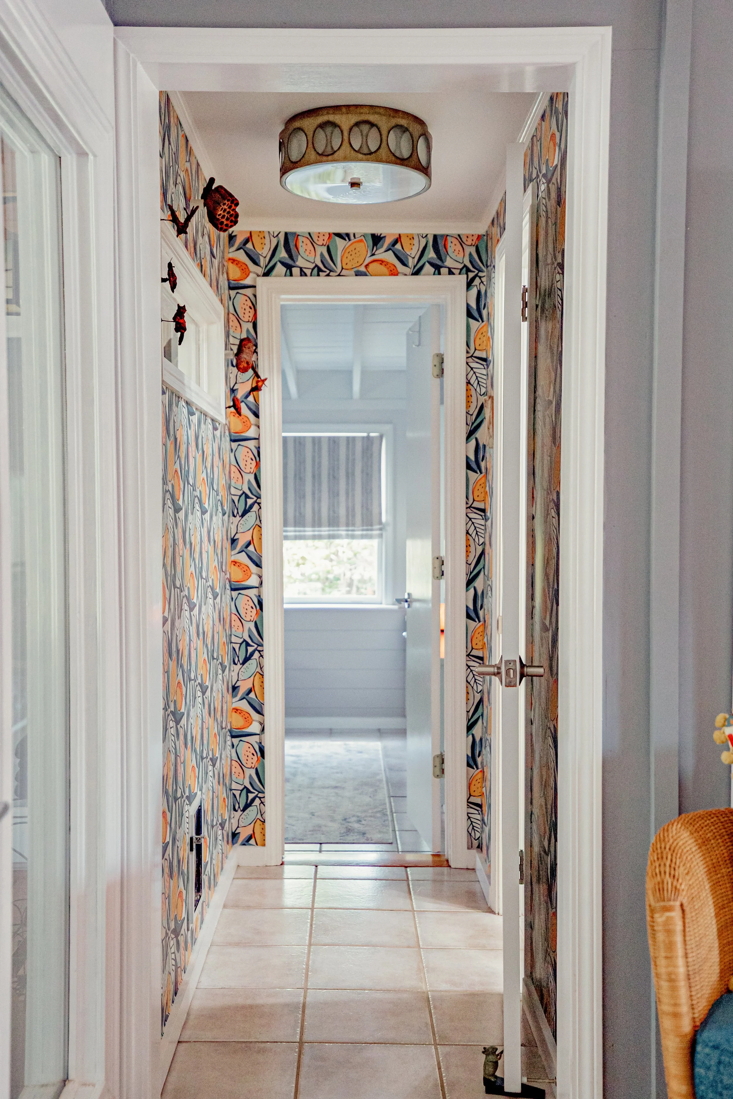 A cheerful hallway at Gilmer Street brought to life with expressive wallpaper and custom touches that connect the home’s eclectic design. This bright transitional space celebrates personality and craftsmanship in a way that feels both refined and whi