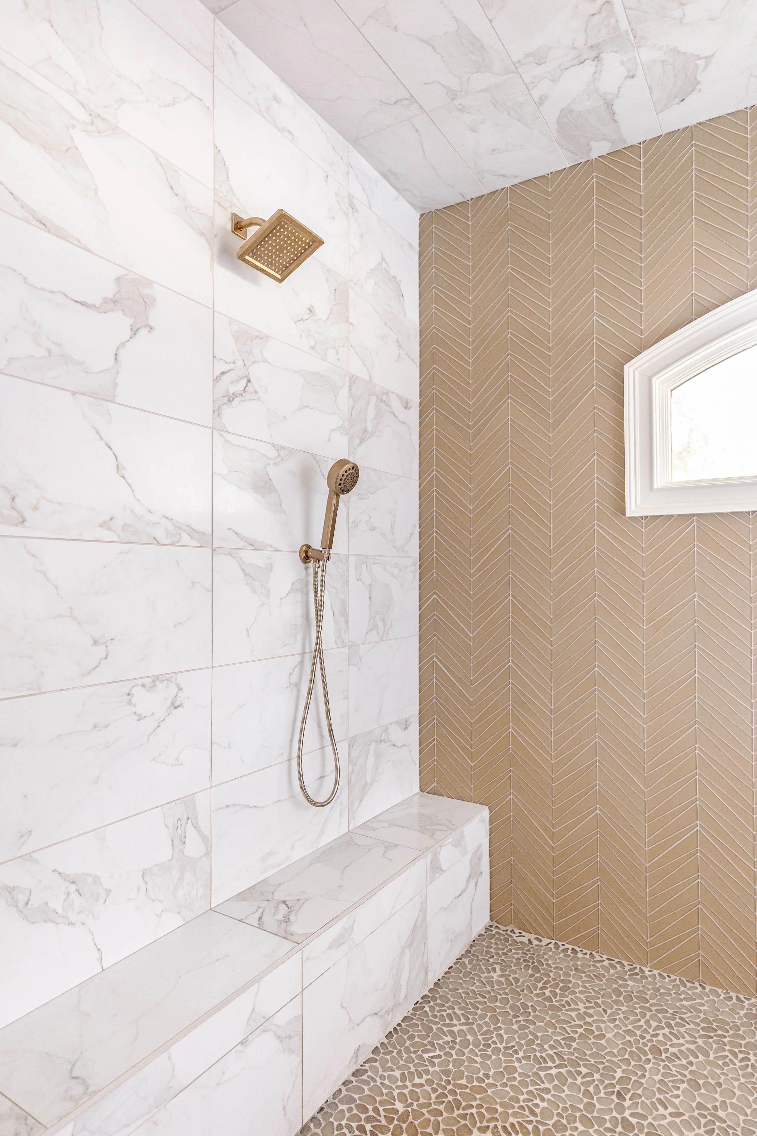 A spa-inspired primary bathroom designed for relaxation and daily ritual. Elevated materials, balanced lighting, and thoughtful layouts create a space that feels calming, timeless, and refined. The textured wallpaper custom tile, and gold finishes br
