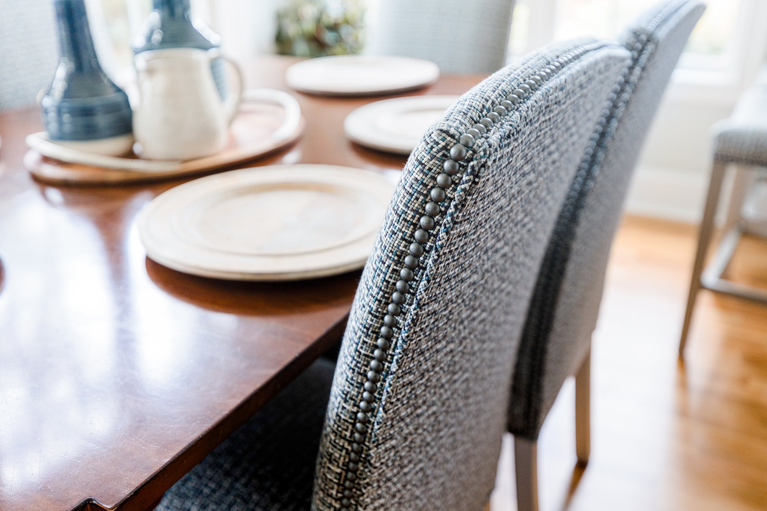 A sunlit eat-in dining area by Cossart Design, featuring expansive windows, elegant furnishings, and thoughtful details that create a bright, inviting space for meals and gatherings. The design balances Southern charm with elevated style, perfect for