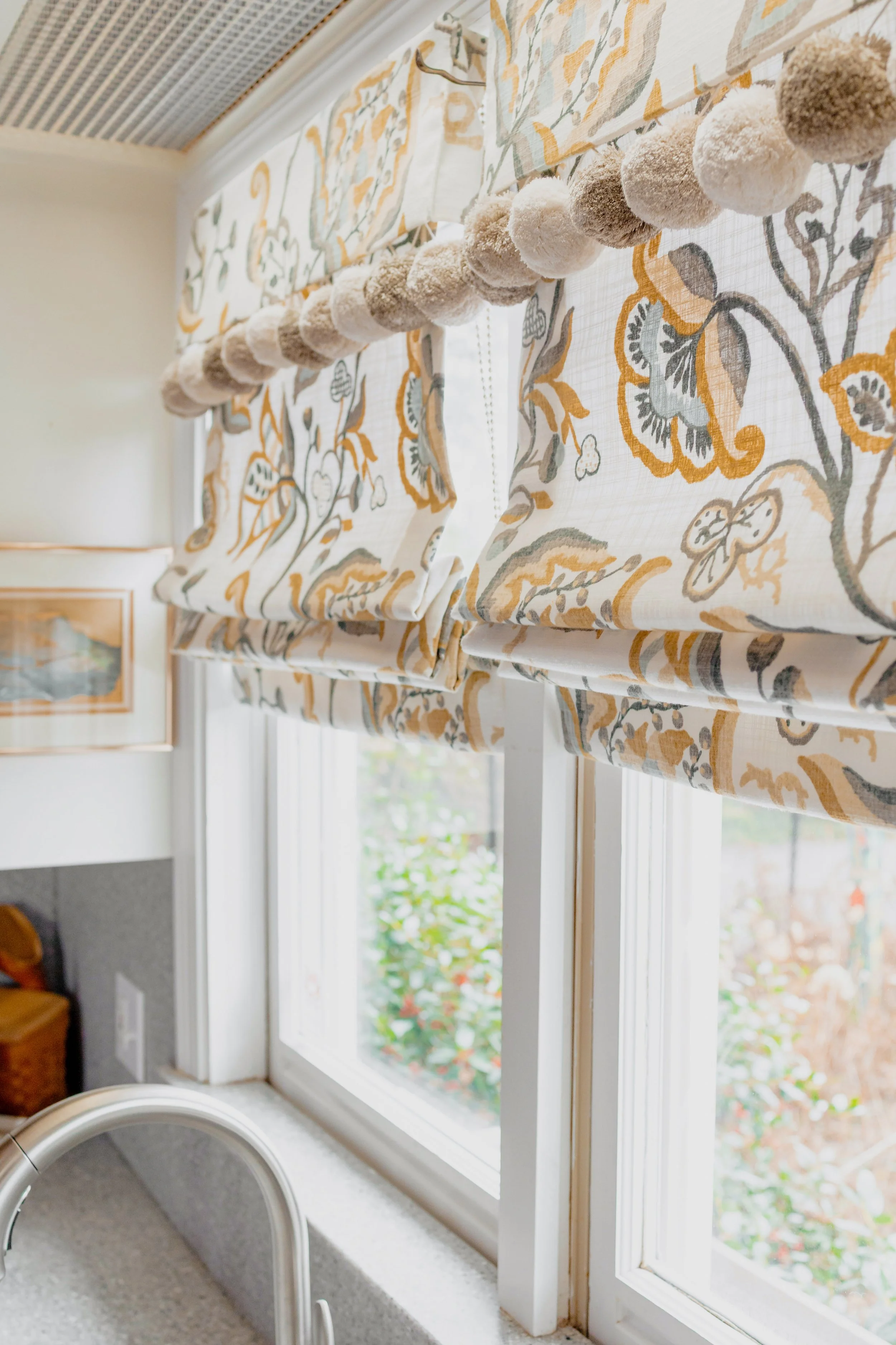 A classic kitchen designed by Cossart Design in Perry, GA, where timeless details meet modern functionality. Custom cabinetry, tailored window treatments, and carefully curated finishes create a space that is both elegant and inviting. The adjacent b