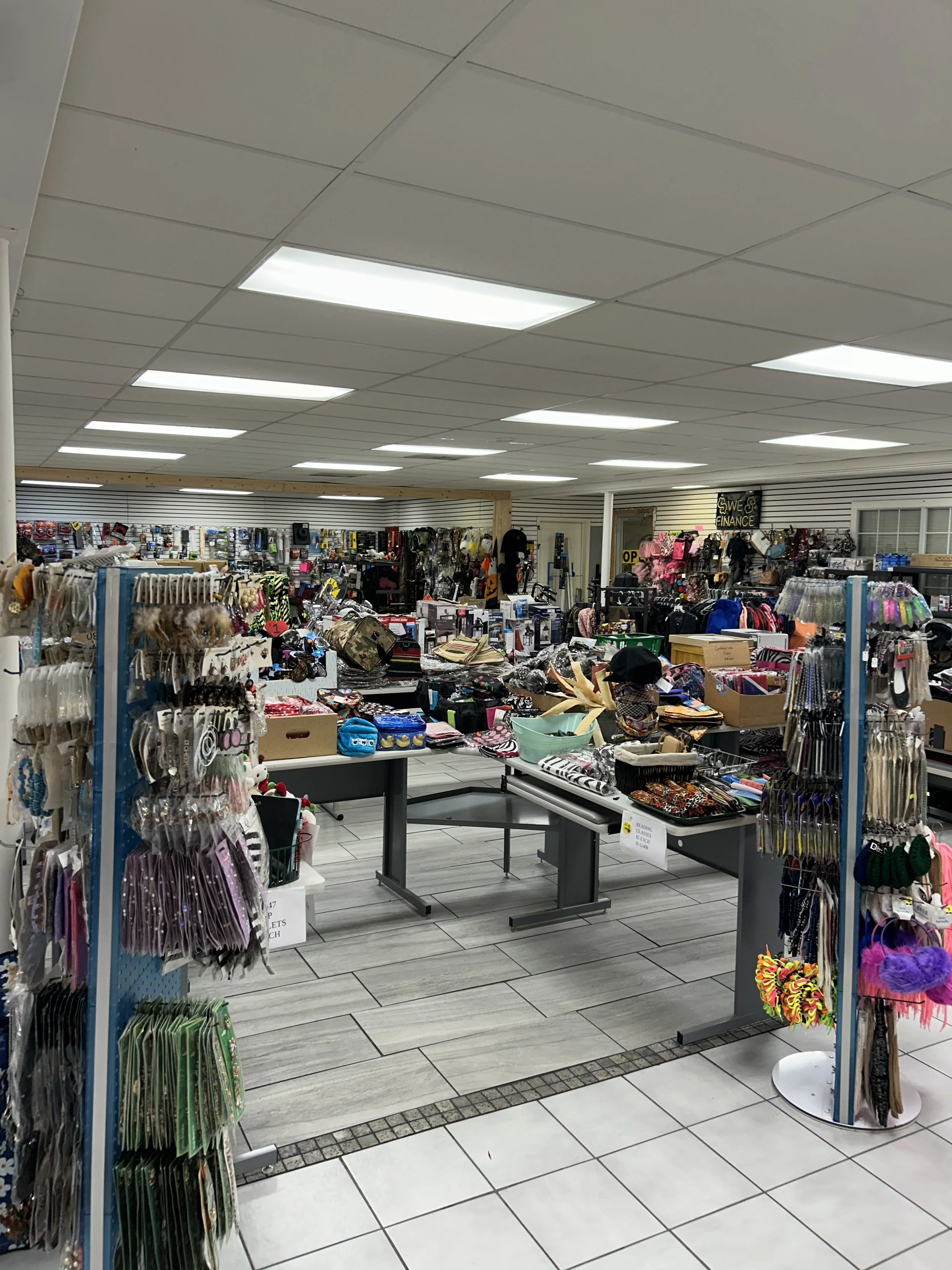 Interior of a thrift store with various clothing and accessories displayed on shelves and racks.