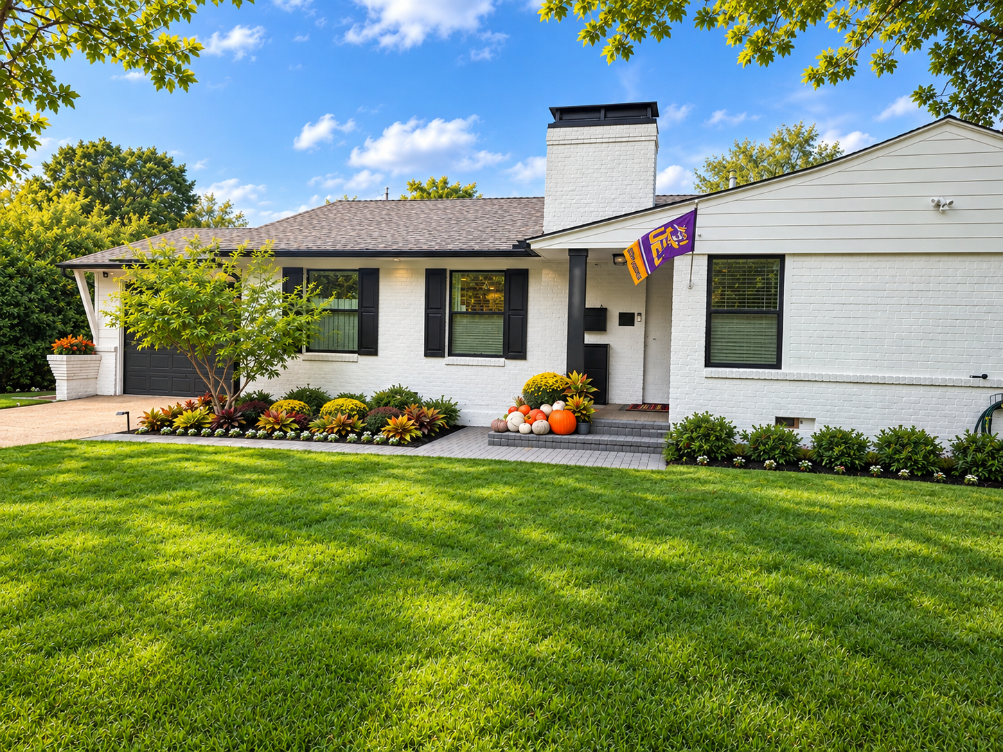 White Brick Ranch with LSU Flag and Autumn Landscaping.png
