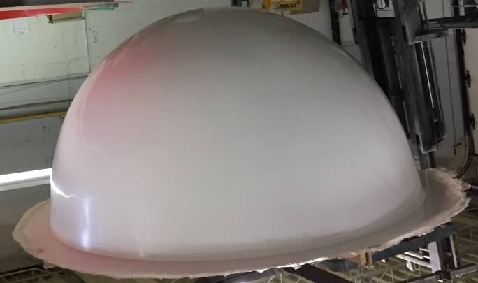 A large white dome-shaped object in an industrial setting.