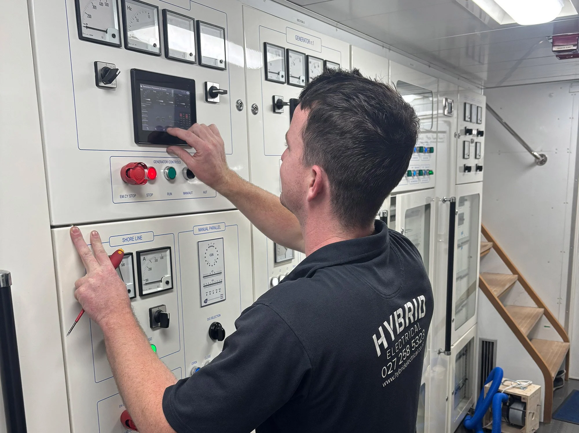 Hybrid Electrical electrician or engineer operating a custom DIEF screen in a boat.