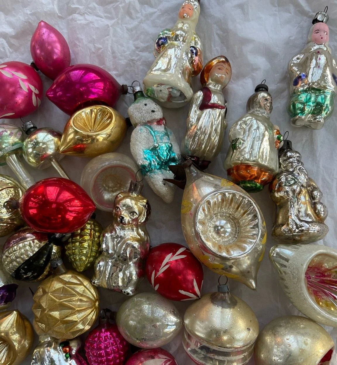 Mixed figural, reflector, and molded glass Christmas ornaments with caps and worn finishes
