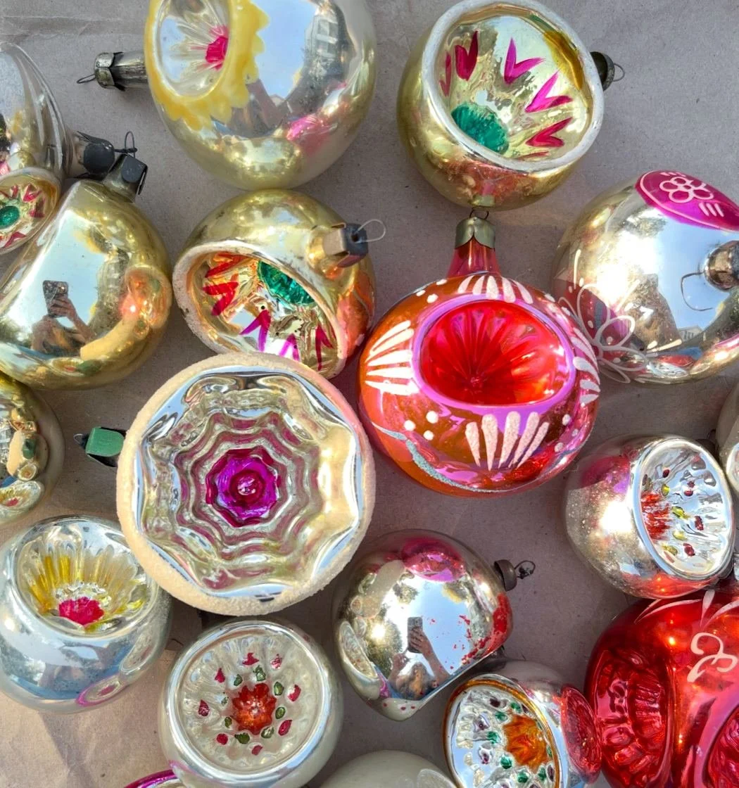Vintage reflector ornaments with silvering, painted indents, caps, and surface wear