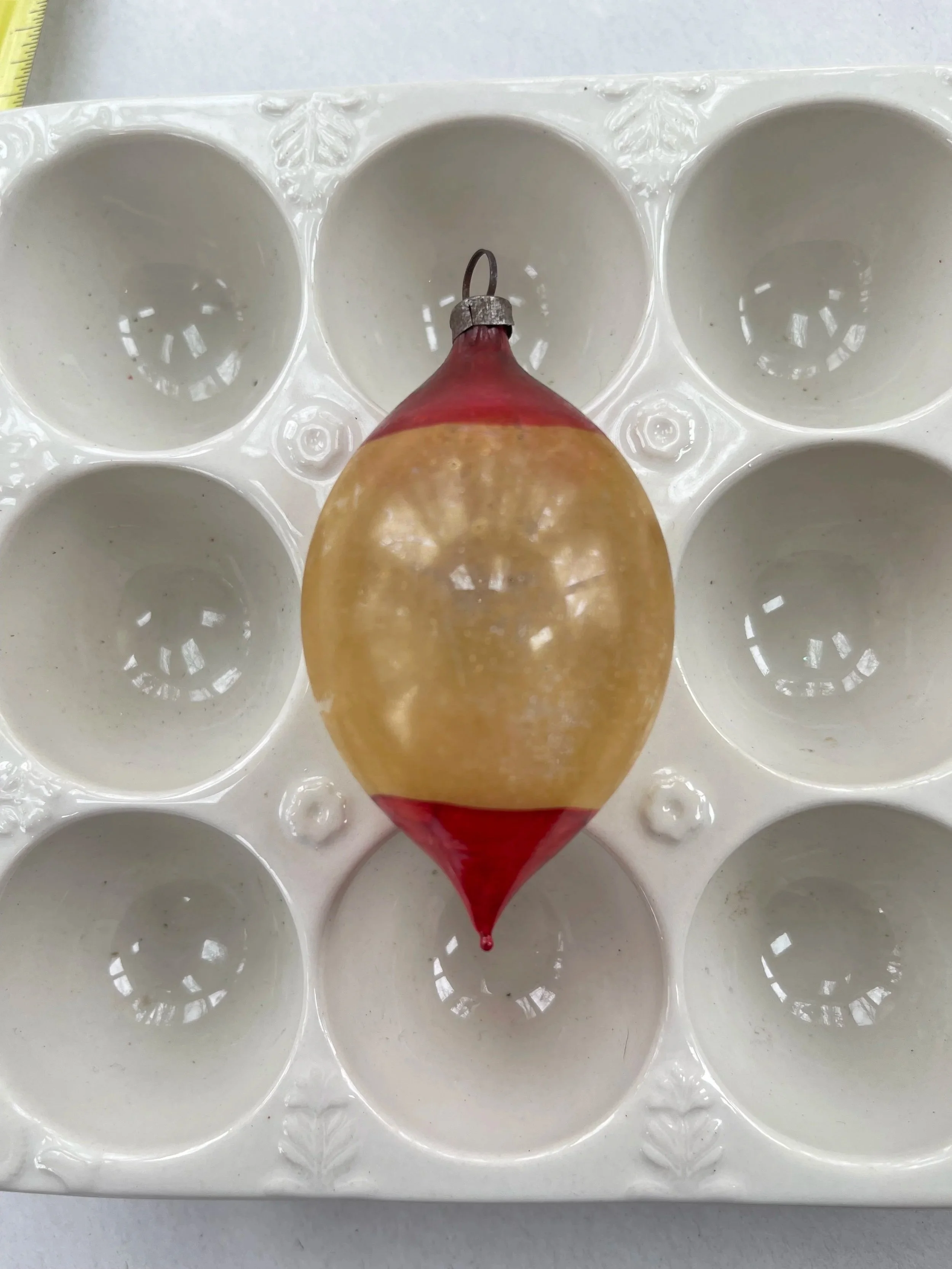 Antique German oval glass ornament in amber and red.