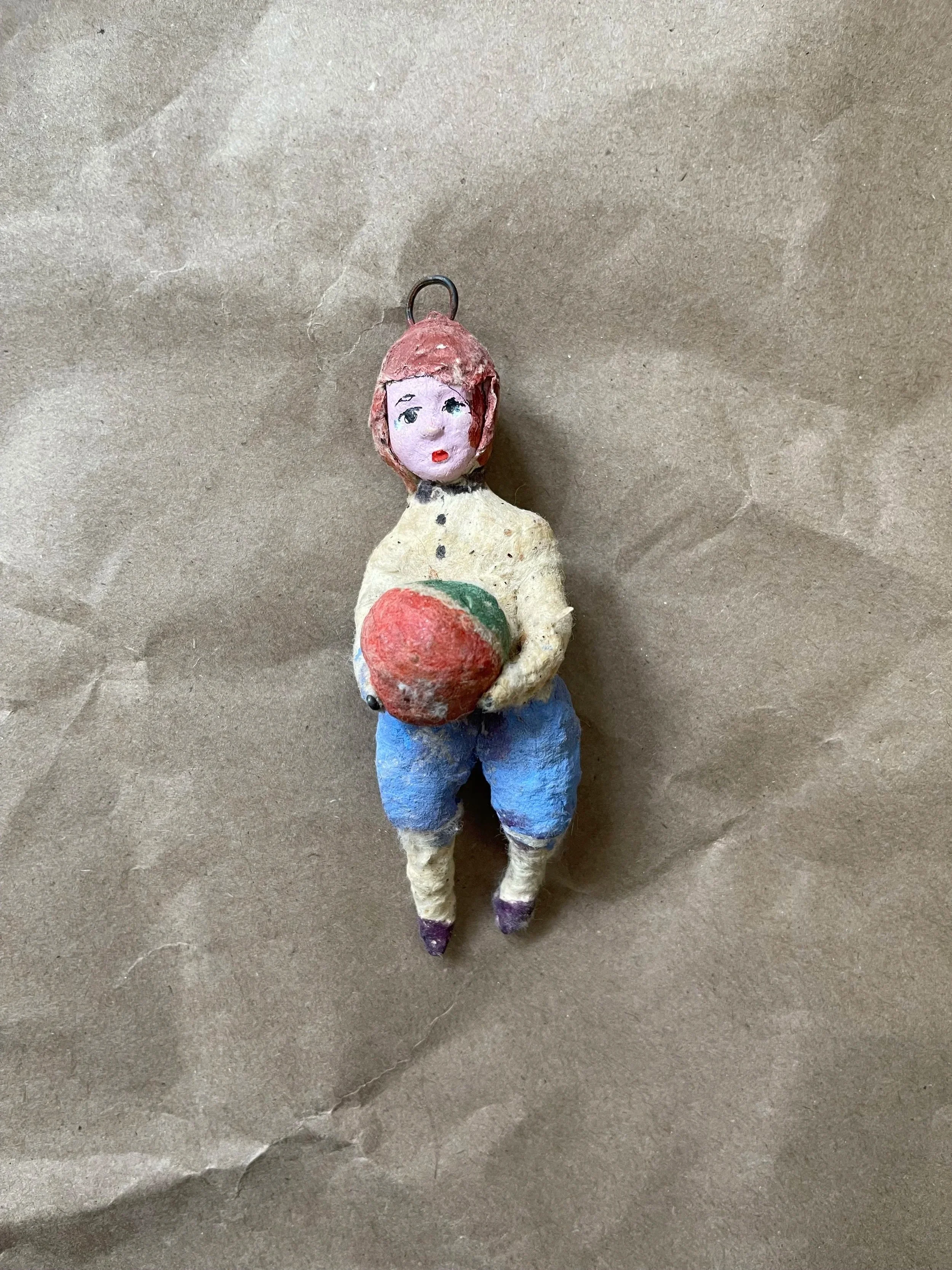 Russian spun-cotton child figure holding a ball.