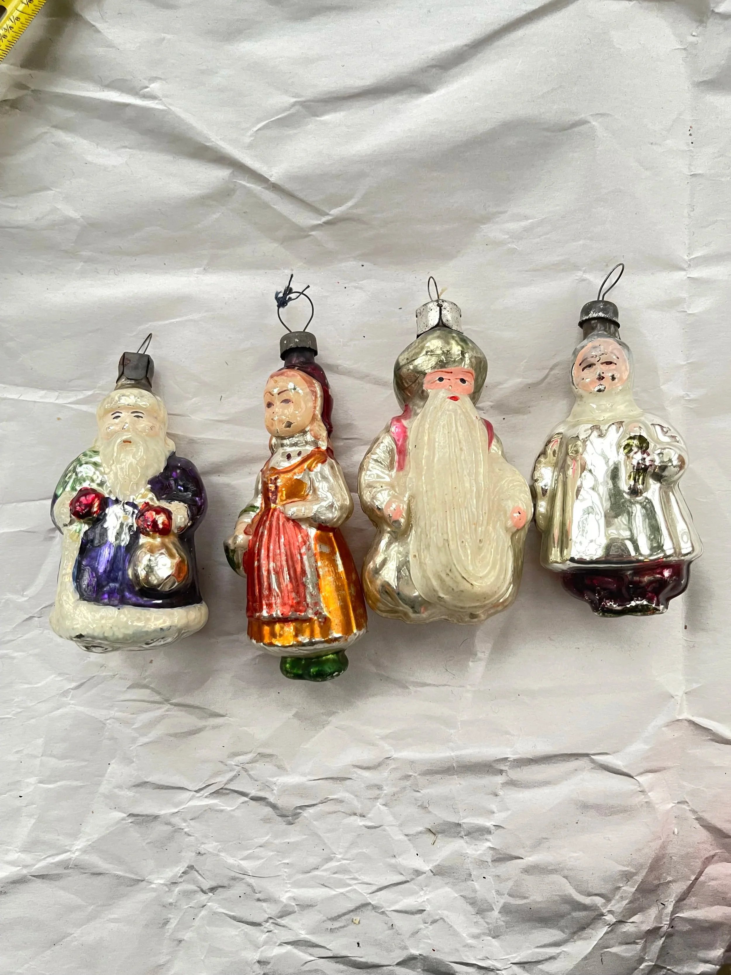 Set of four midcentury figural Christmas ornaments.
