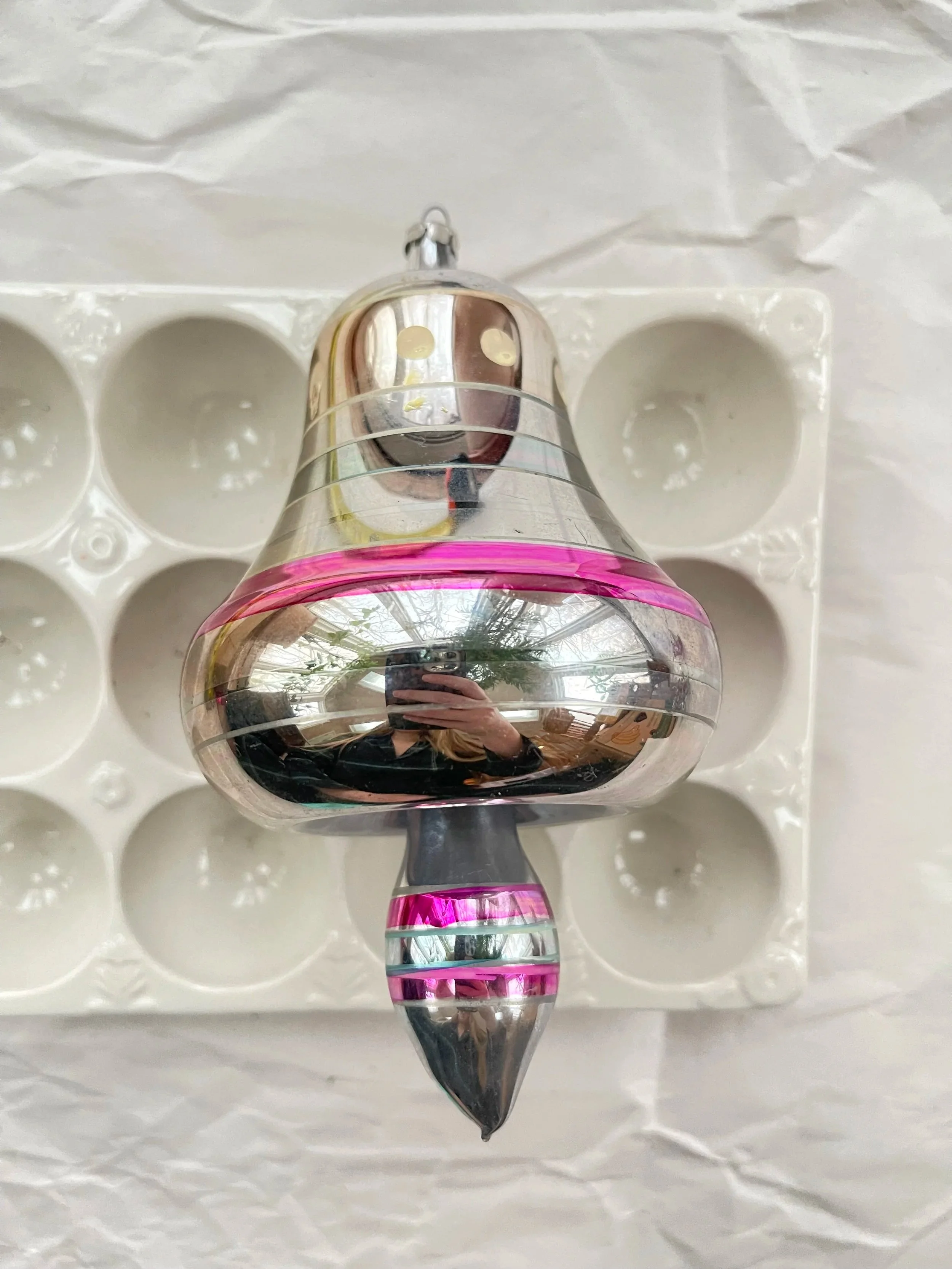 Large silver and magenta bell Christmas ornament.