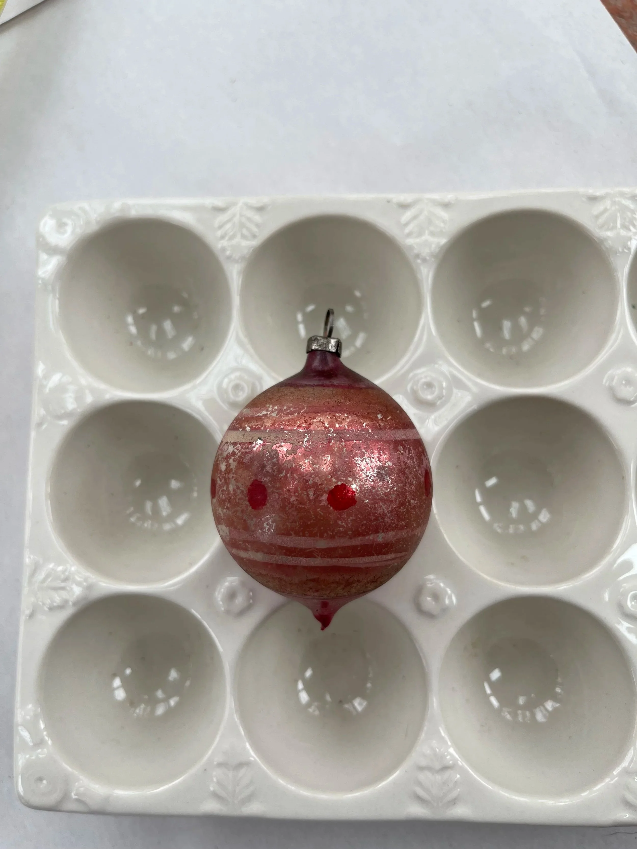 Antique German red glass ball ornament with a dot design.