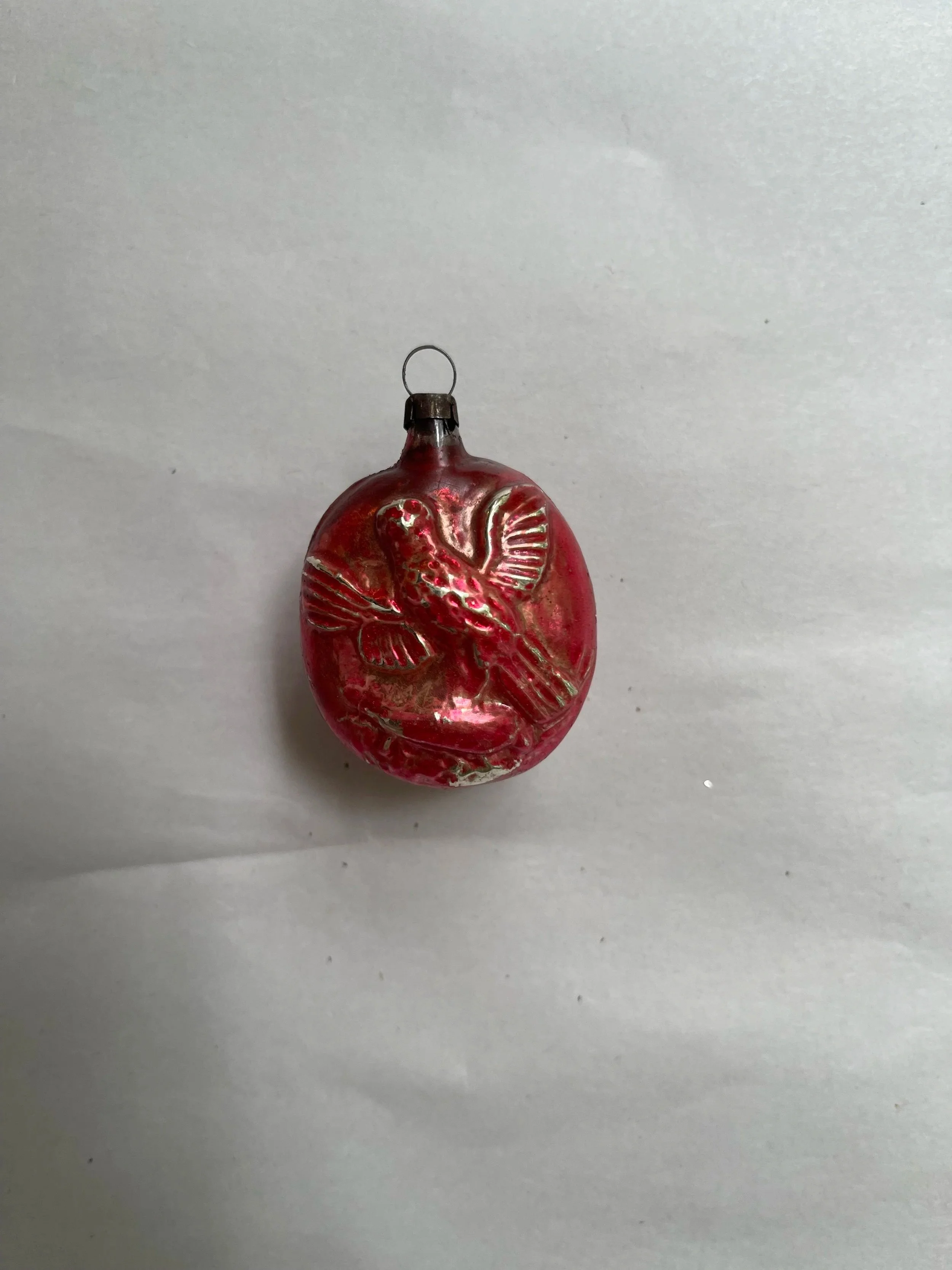 Antique German glass Christmas ornament with a bird perched above a cornucopia.