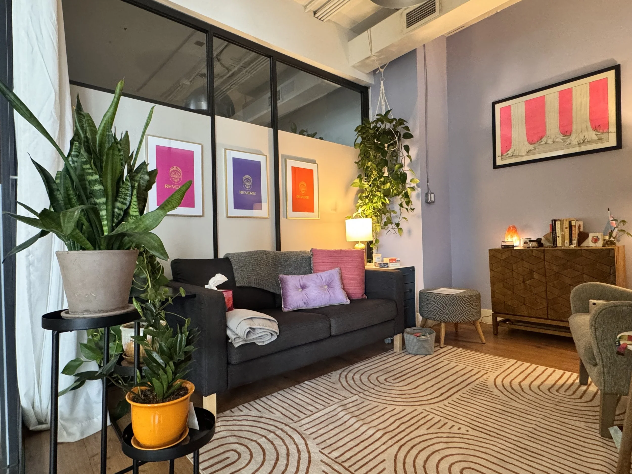a space, colorful therapy office with midcentury modern and boho decor with plants and calm lighting