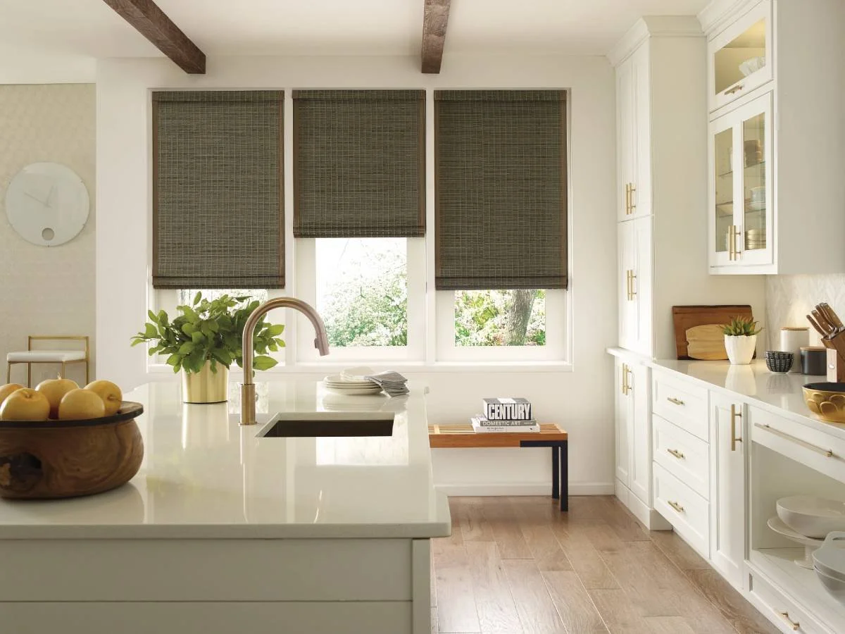 Hunter Douglas Provenance® Woven Wood Shades covering three windows in a row in a kitchen.